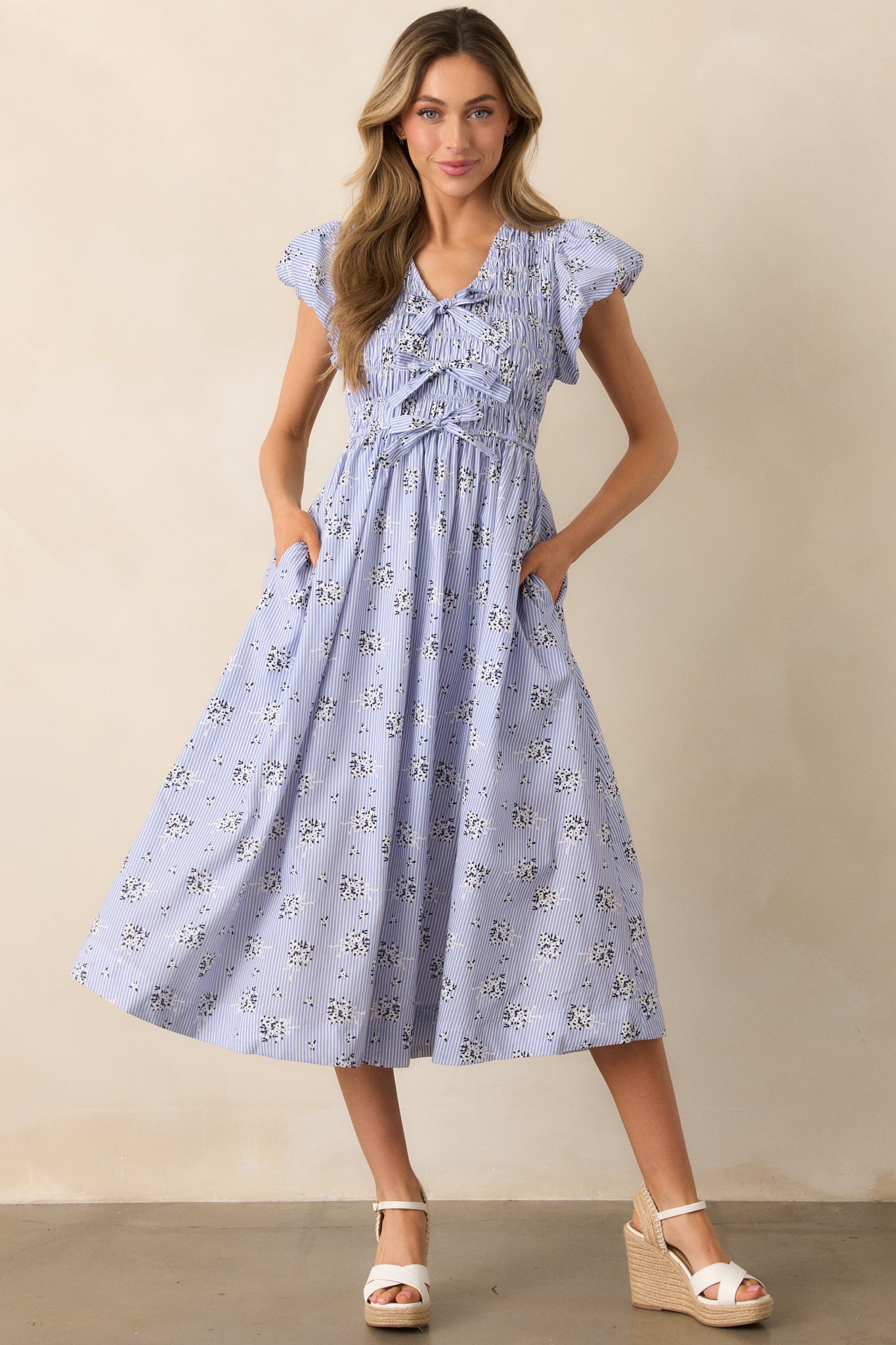 Complete look at the blue dress, showcasing the puff sleeve silhouette and placement of the side pockets.