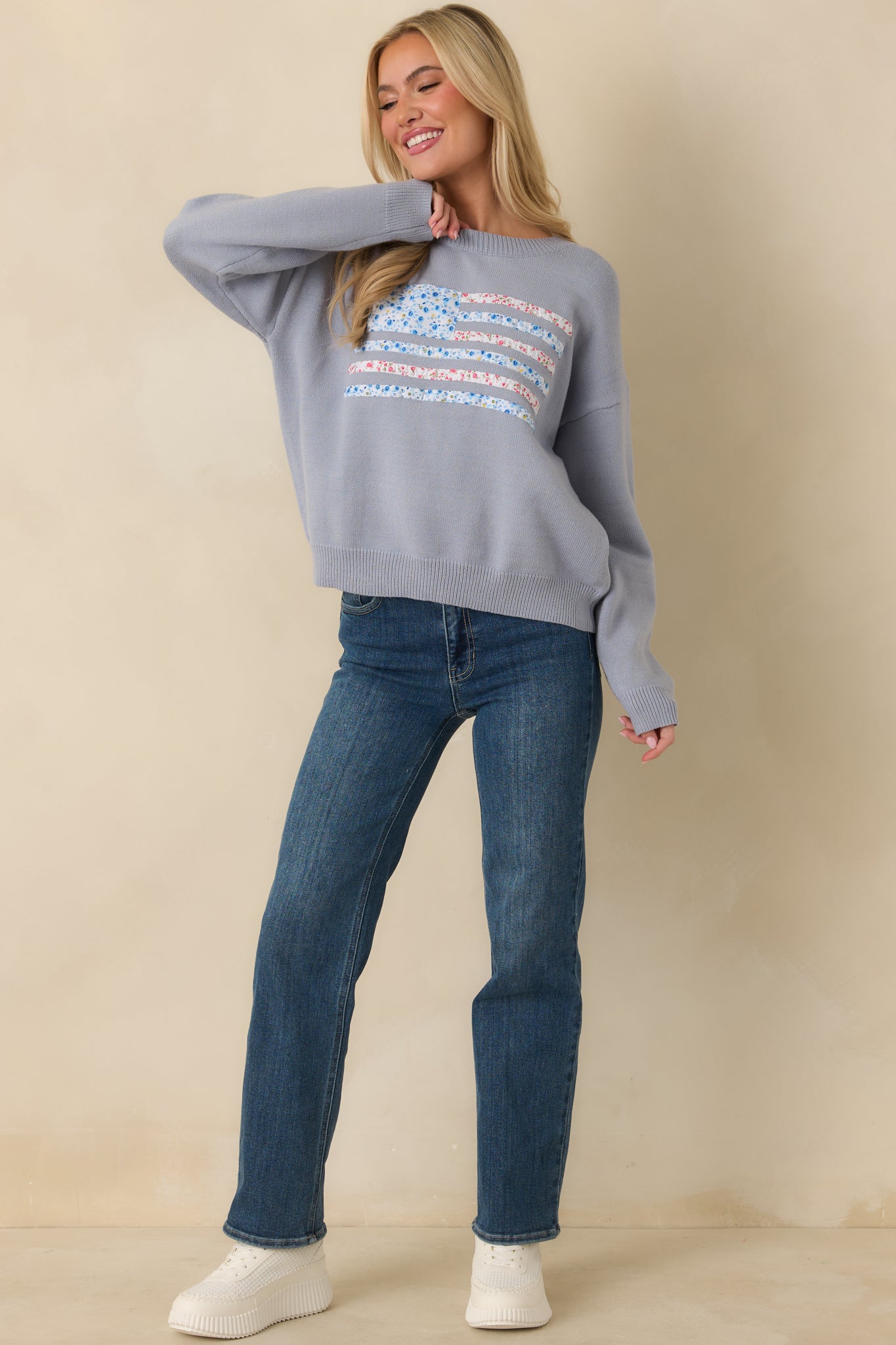 Front view of dusty blue knit sweater featuring relaxed fit, ribbed crew neckline, and long sleeves.