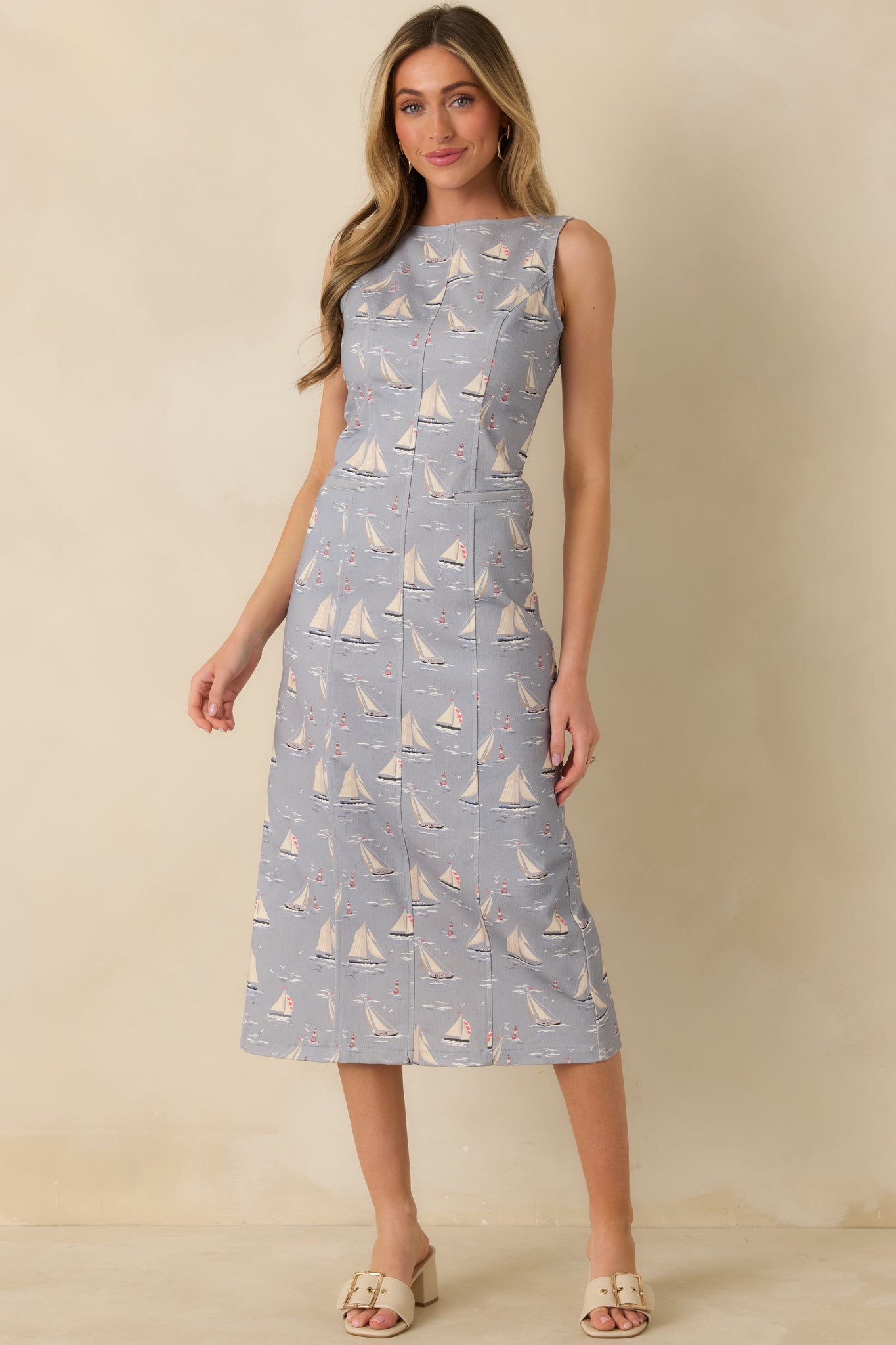 Relaxed-fit dusty blue sleeveless midi dress showcasing a straight midi-length silhouette and soft cotton-blend texture.