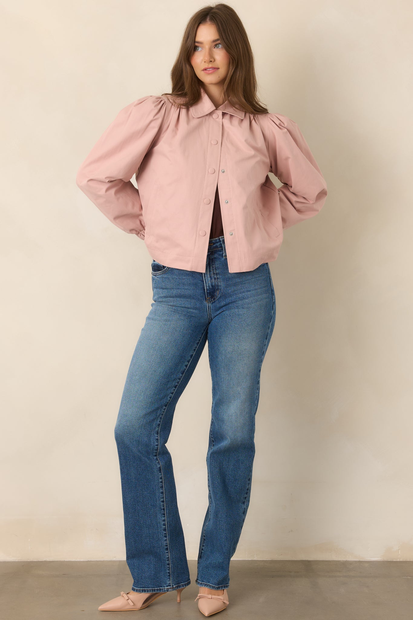 Dusty pink cropped jacket featuring a pointed collar, snap front closure, gathered shoulders, voluminous puff sleeves, and elasticized cuffs.