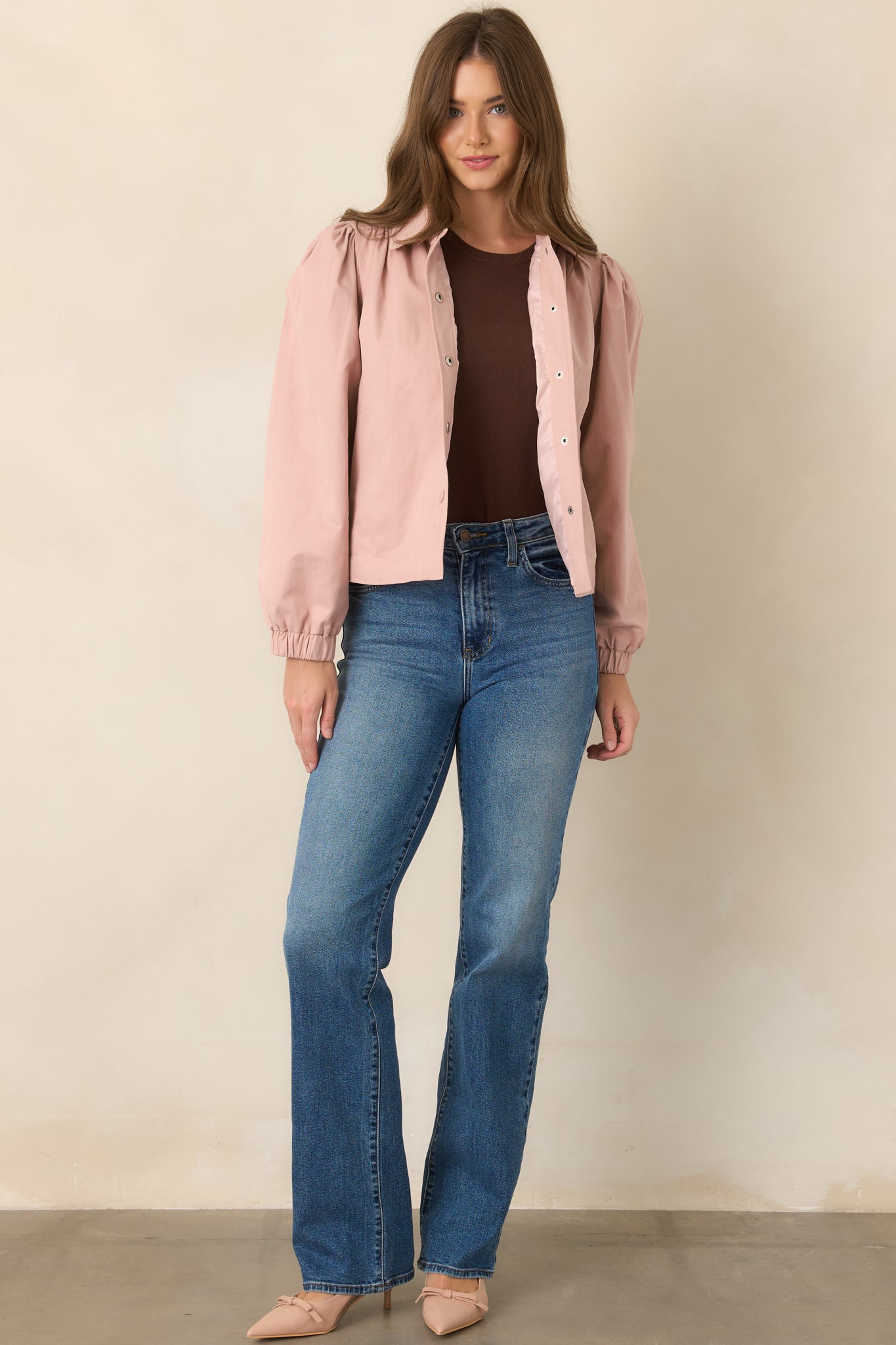 Modern dusty pink jacket showcasing gathered shoulder seams, rounded puff sleeves, elasticized cuffs, and a clean cropped hem.