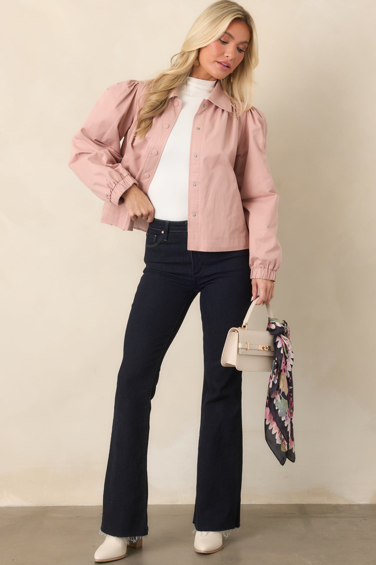 Dusty pink jacket with softly structured puff sleeves created by gathered shoulder detailing.