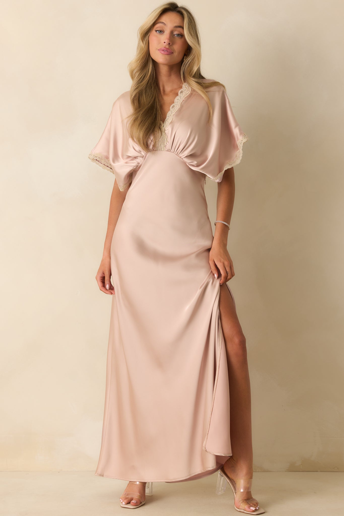 Satin maxi dress in dusty pink with gathered bust, lace trim accents, and sleek, fluid silhouette