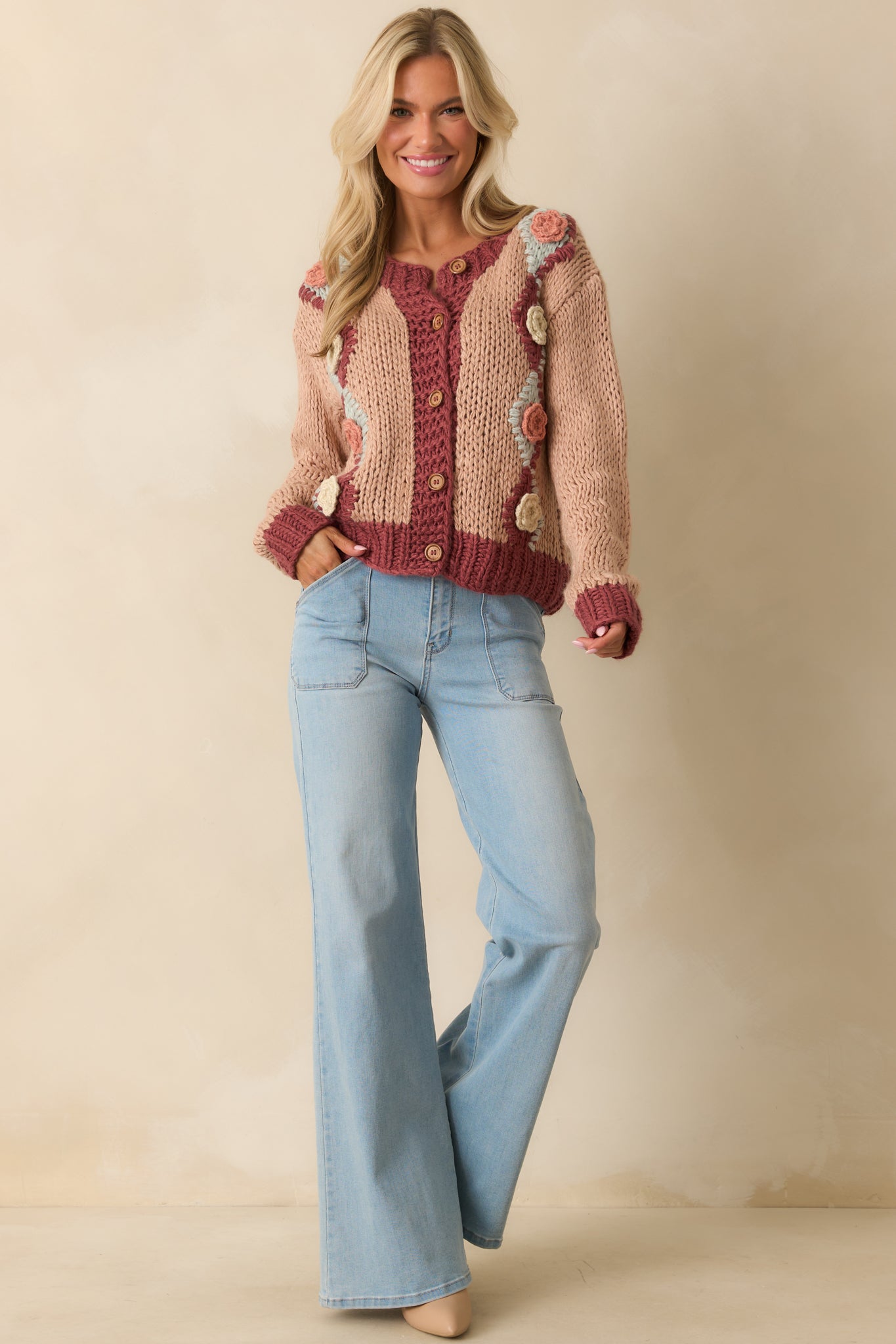 Dusty rose chunky knit cardigan with 3D floral crochet appliqués and button front closure.