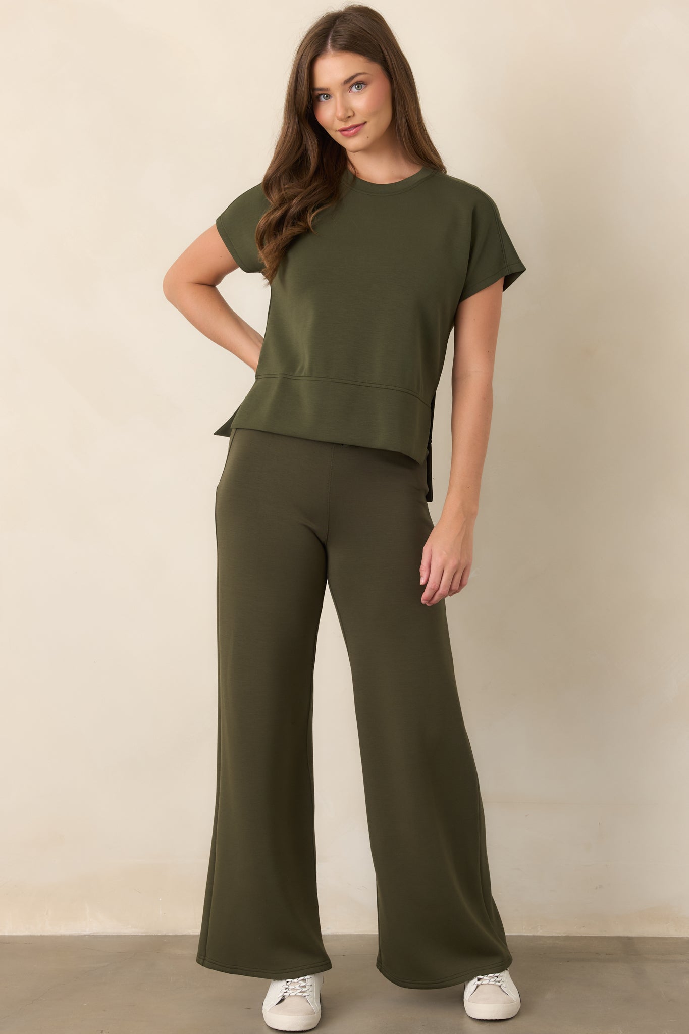 Earthy olive top featuring a polished high-low hem and side slits that create an easy, fluid finish.