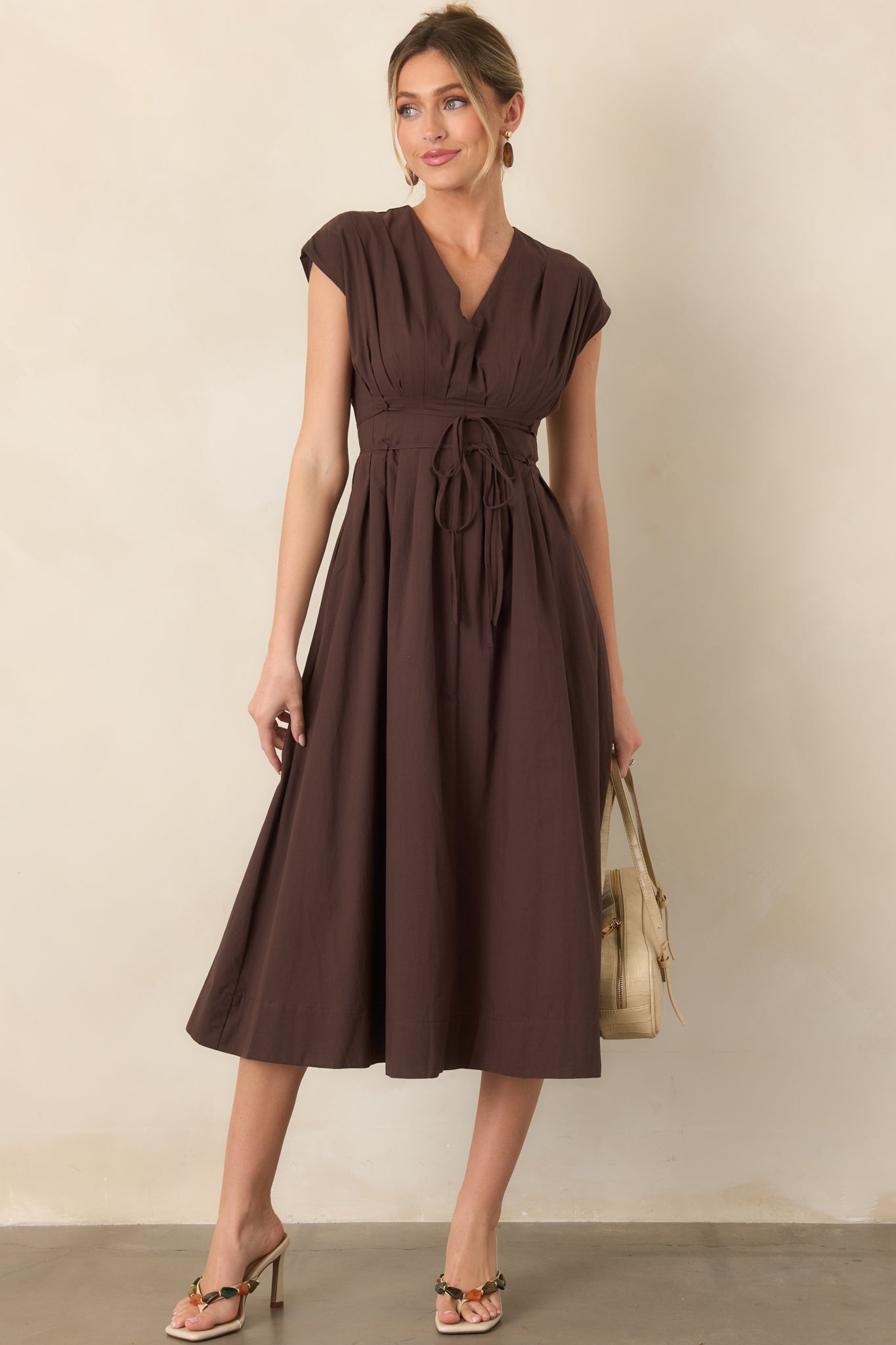 Heeled sandals with sleek square toes, slip-on styling, structured heels, and straps accented with mixed stone details in rich earthy tones.