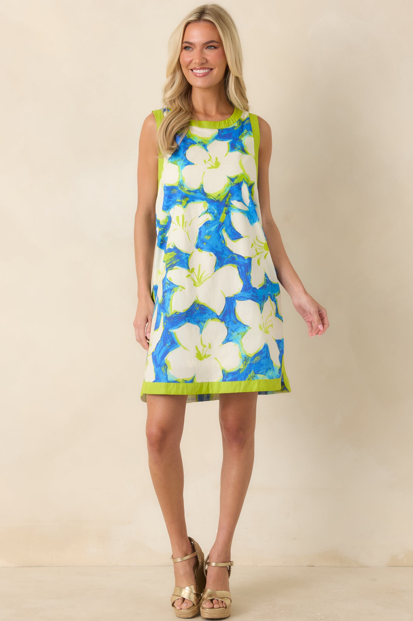 Easy-wear mini dress with green trimmed arm openings, hem detailing, and subtle movement.