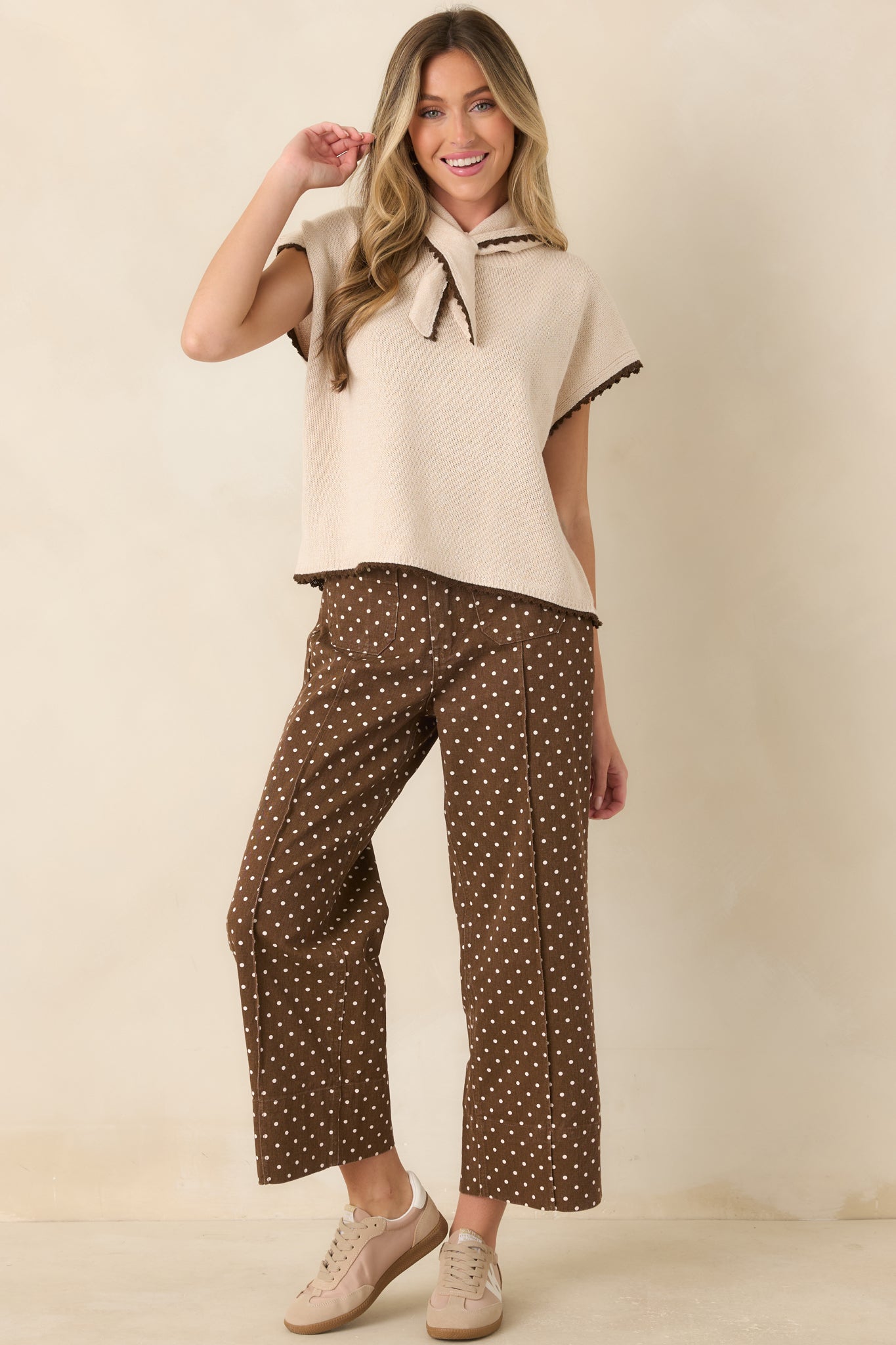 Ecru cotton knit top featuring a built-in scarf neckline, chocolate contrast trim, short sleeves, and a relaxed boxy silhouette.