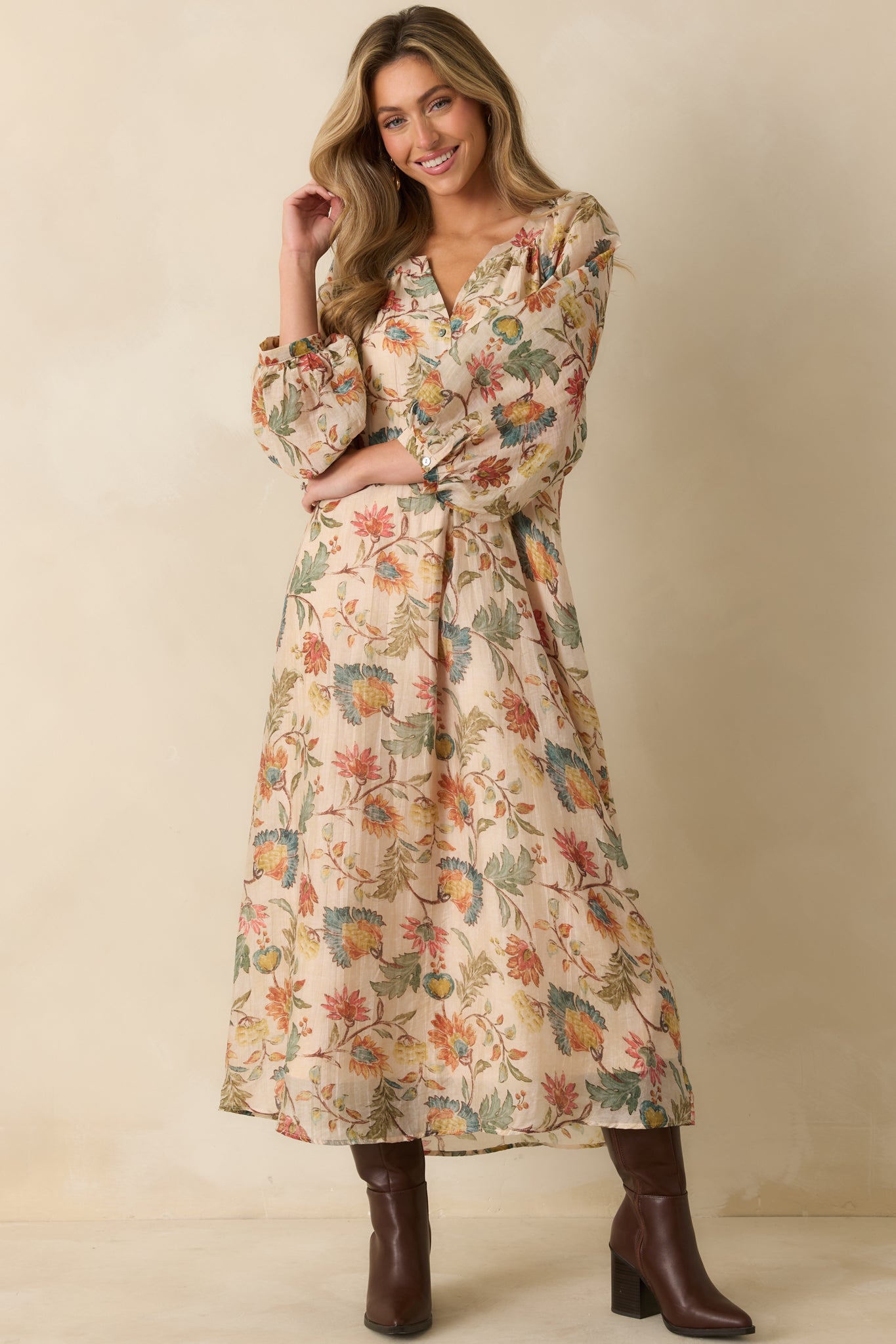 The ecru floral maxi dress highlights hidden side pockets and a graceful, lightweight silhouette.
