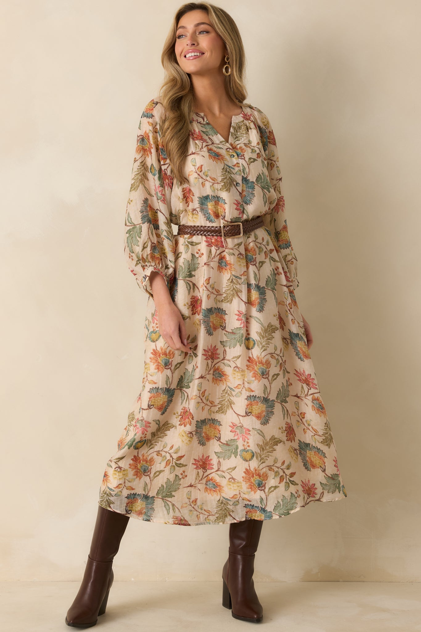 Ecru floral maxi dress with a gentle split neckline and flowing skirt, creating an easygoing, feminine look.