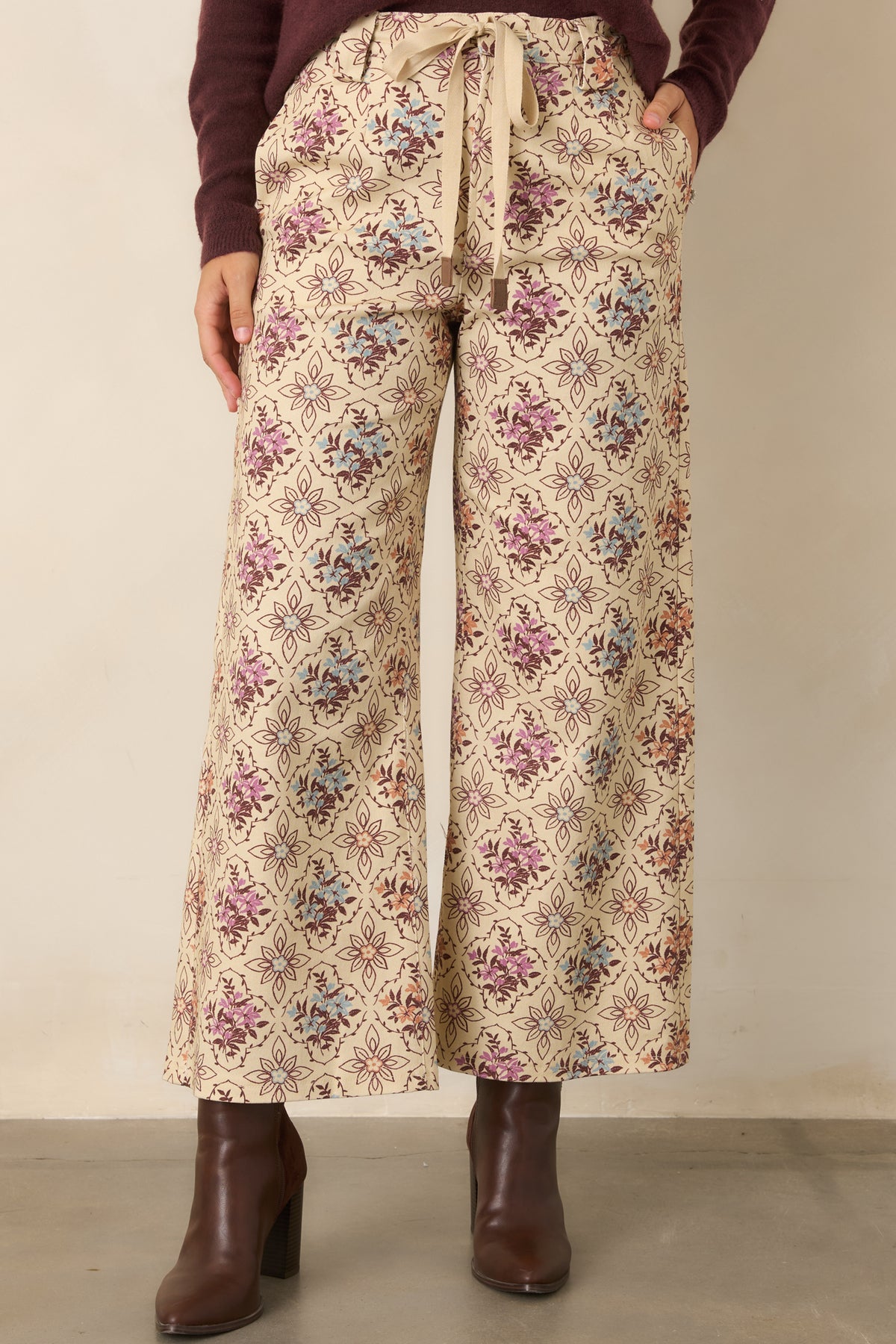 Ecru pants highlighting the medallion floral print and drawstring detail at the structured waistband.