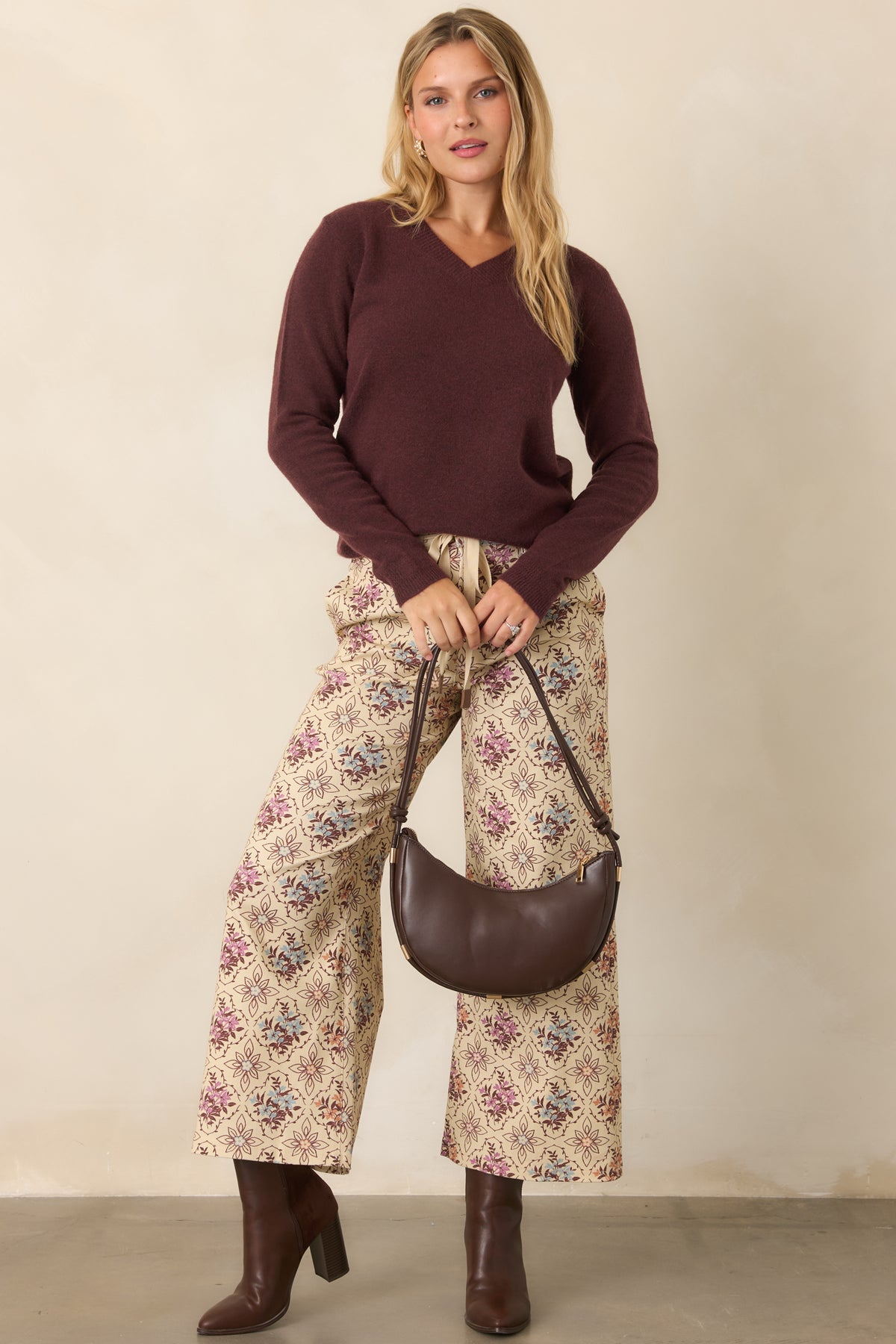 Ecru cropped pants featuring muted medallion florals, a structured waistband, and wide-leg silhouette.