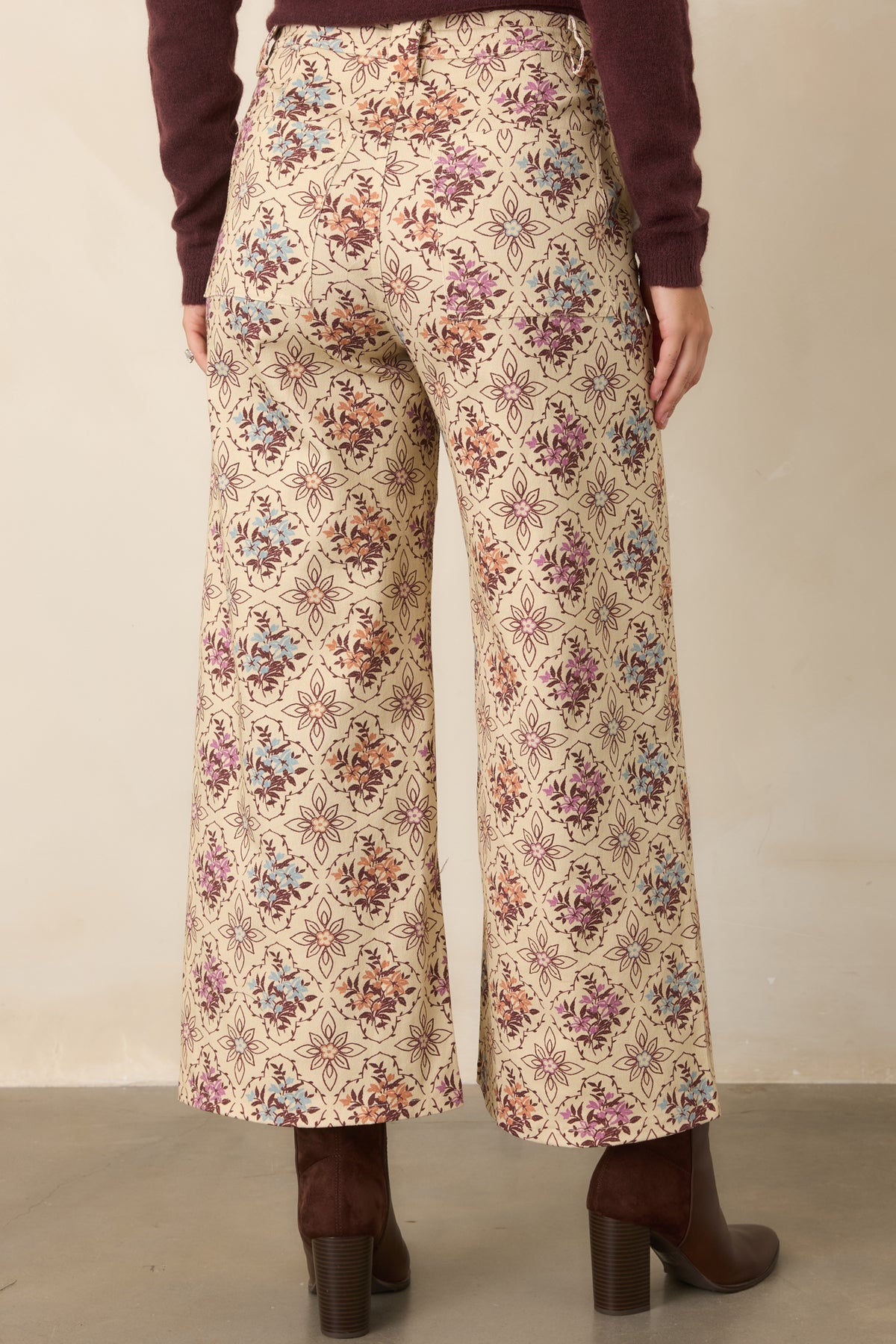 Rear of the ecru pants showcasing the wide-leg shape and back patch pockets.