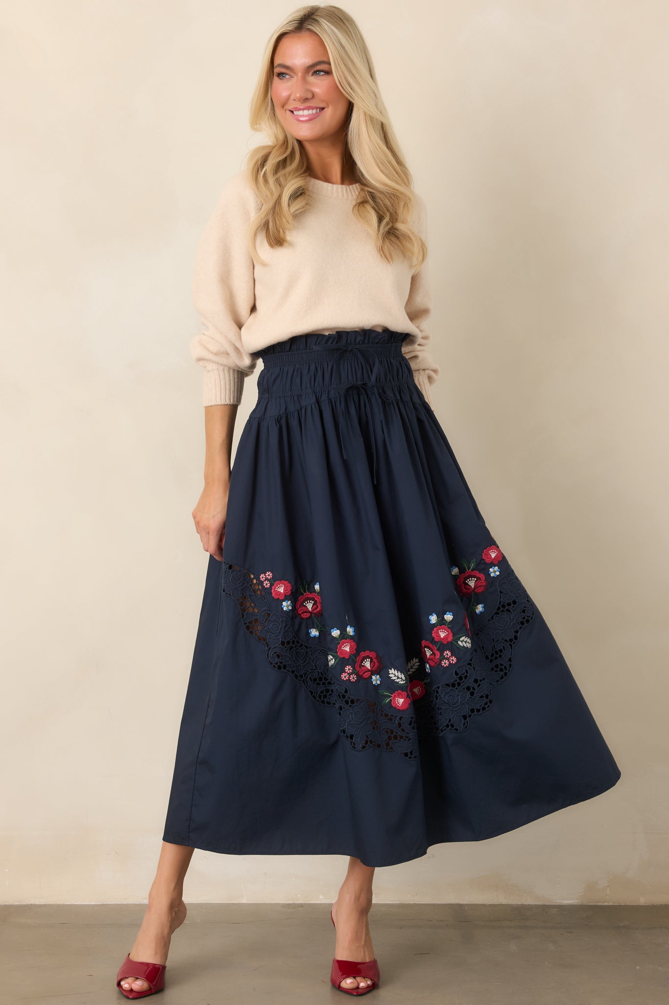 Cozy ecru knit sweater designed with long raglan sleeves, a classic crew neckline, softly gathered sleeve shape, and ribbed edging.