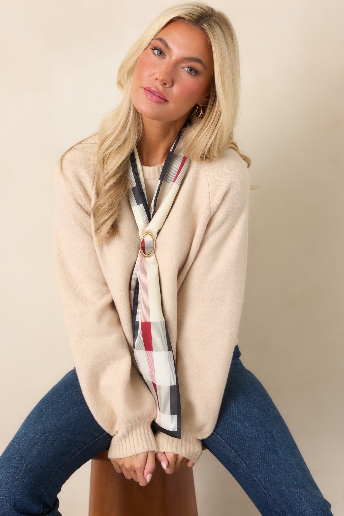 Warm ecru sweater showcasing a softly gathered raglan sleeve shape, ribbed neckline and cuffs, and an easy cropped fit.