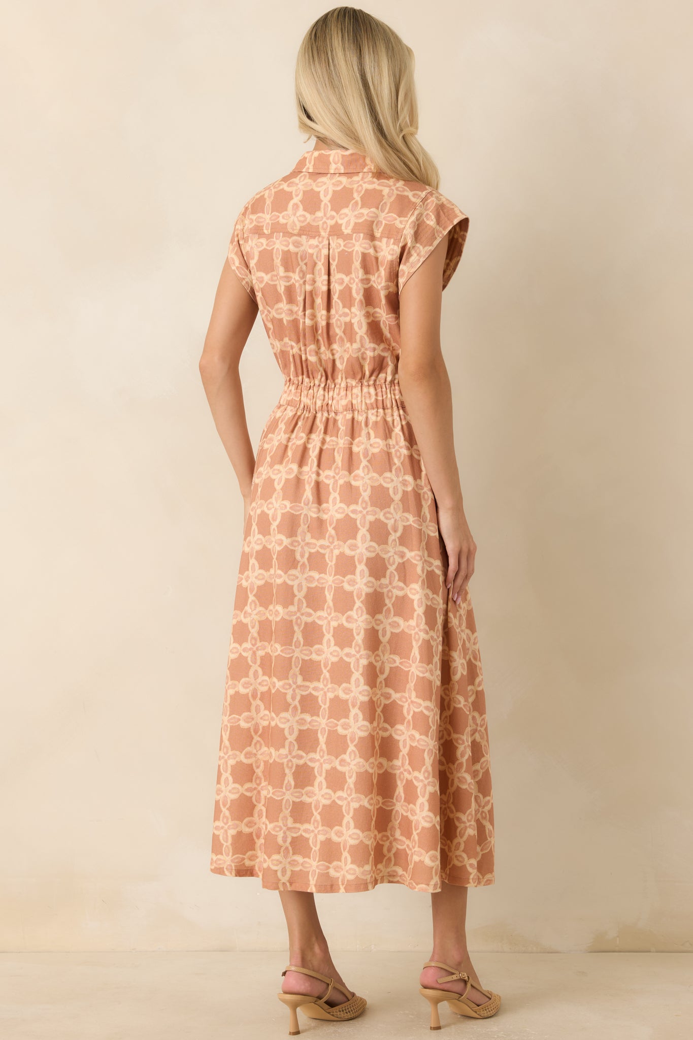 Back of the midi dress featuring an elastic waistband that creates a comfortable fit and a clean, polished silhouette.