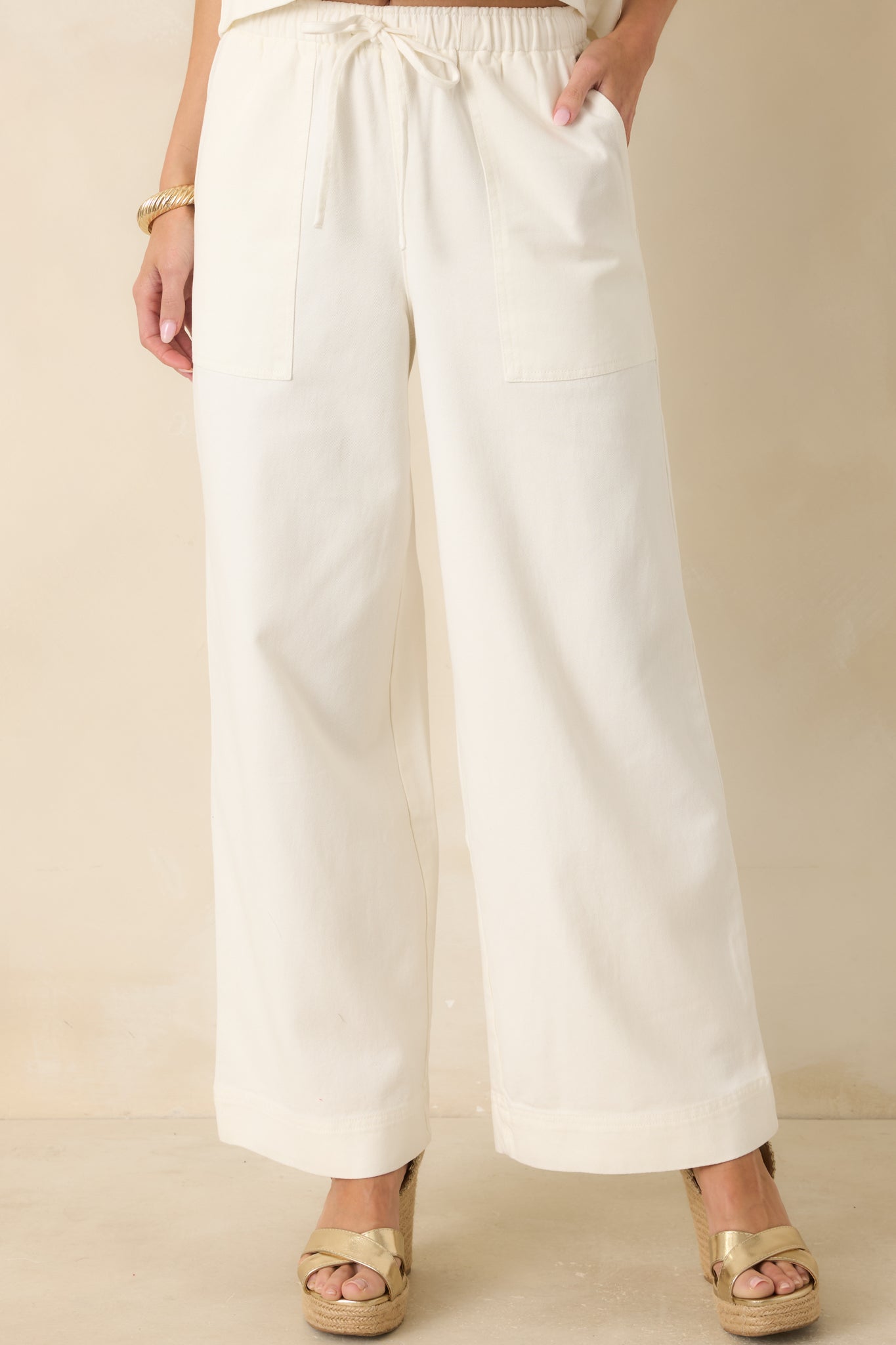 Close front framing of the elastic waistband and drawstring detail designed for an adjustable, comfortable fit.