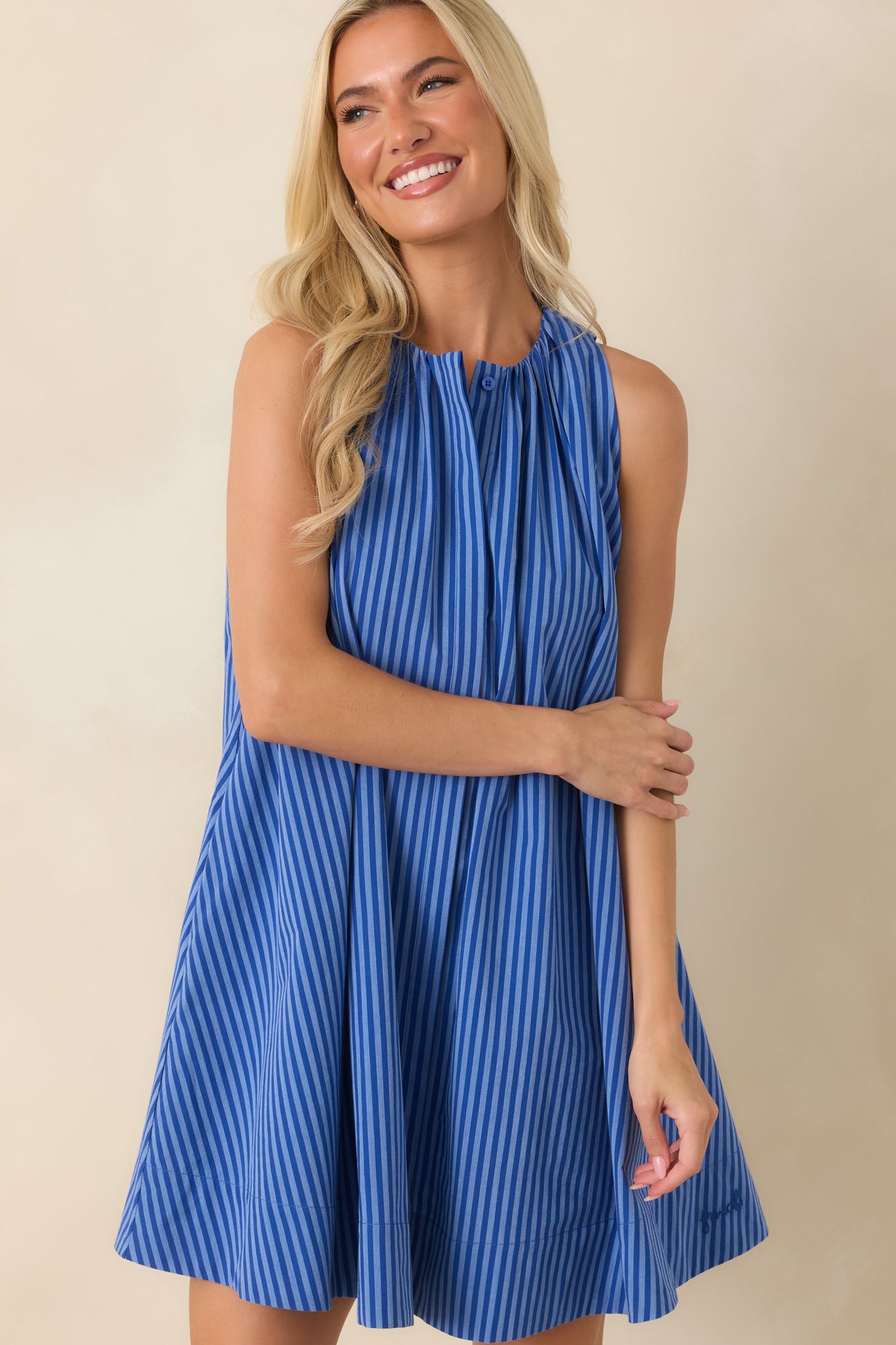Electric blue striped dress highlighting the soft neckline gathers and smooth flowing silhouette.