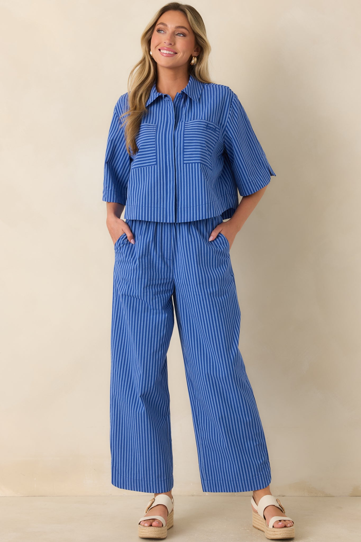 Electric blue cotton pants featuring bold vertical stripes, a relaxed wide-leg silhouette, and an easy pull-on design for everyday comfort.