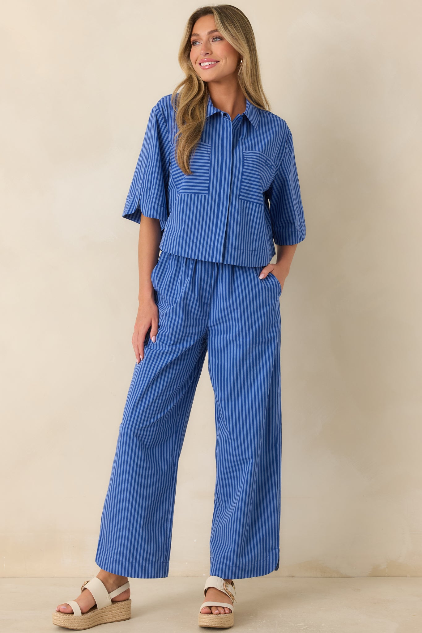 Electric blue striped pants featuring a relaxed wide-leg silhouette, full-length cut, and lightweight cotton fabric.