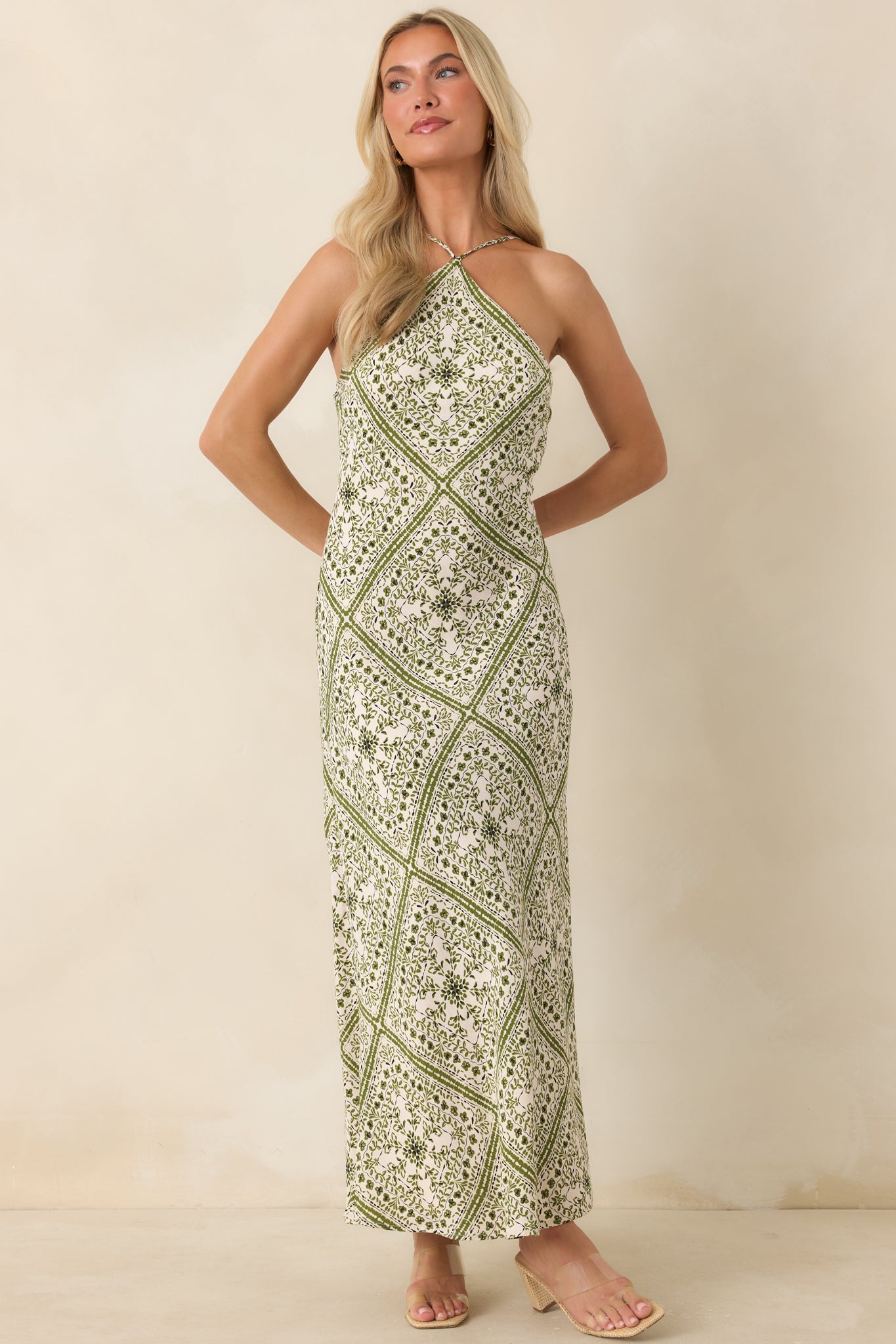 Elegant column midi dress with a vintage floral pattern and a refined, flowing shape.