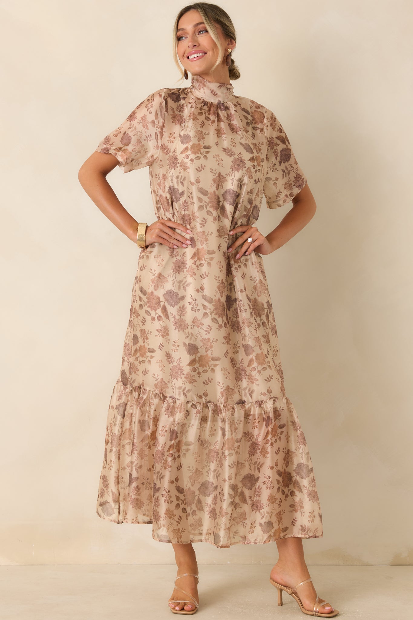 Elegant floral maxi dress highlighting the flowing sheer fabric, lined construction, and dimensional tiered skirt.