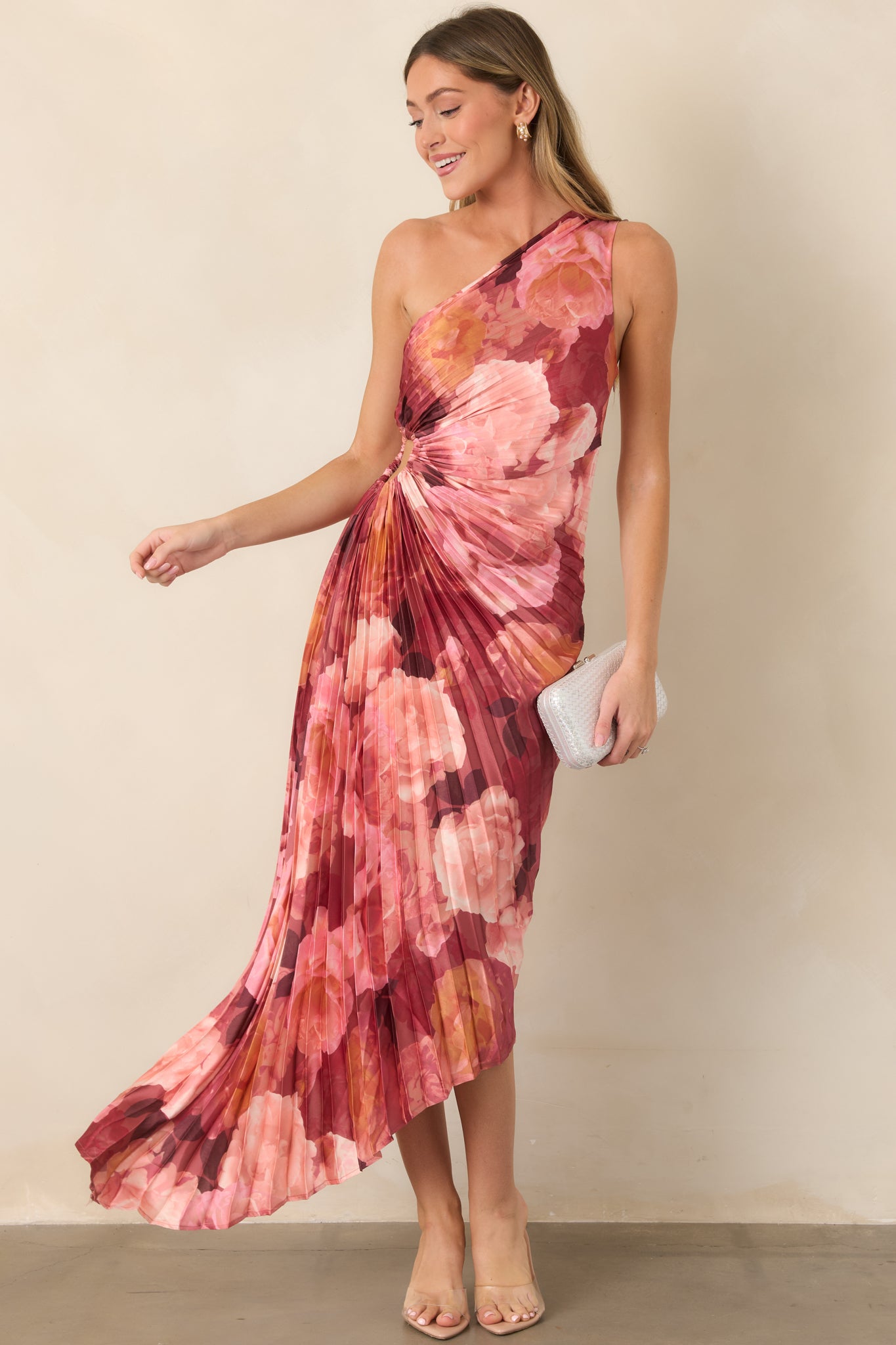 Elegant floral-print satin maxi dress with layered rose and burgundy blooms, a sleek one-shoulder neckline, defined waist, and flowing uneven hemline.