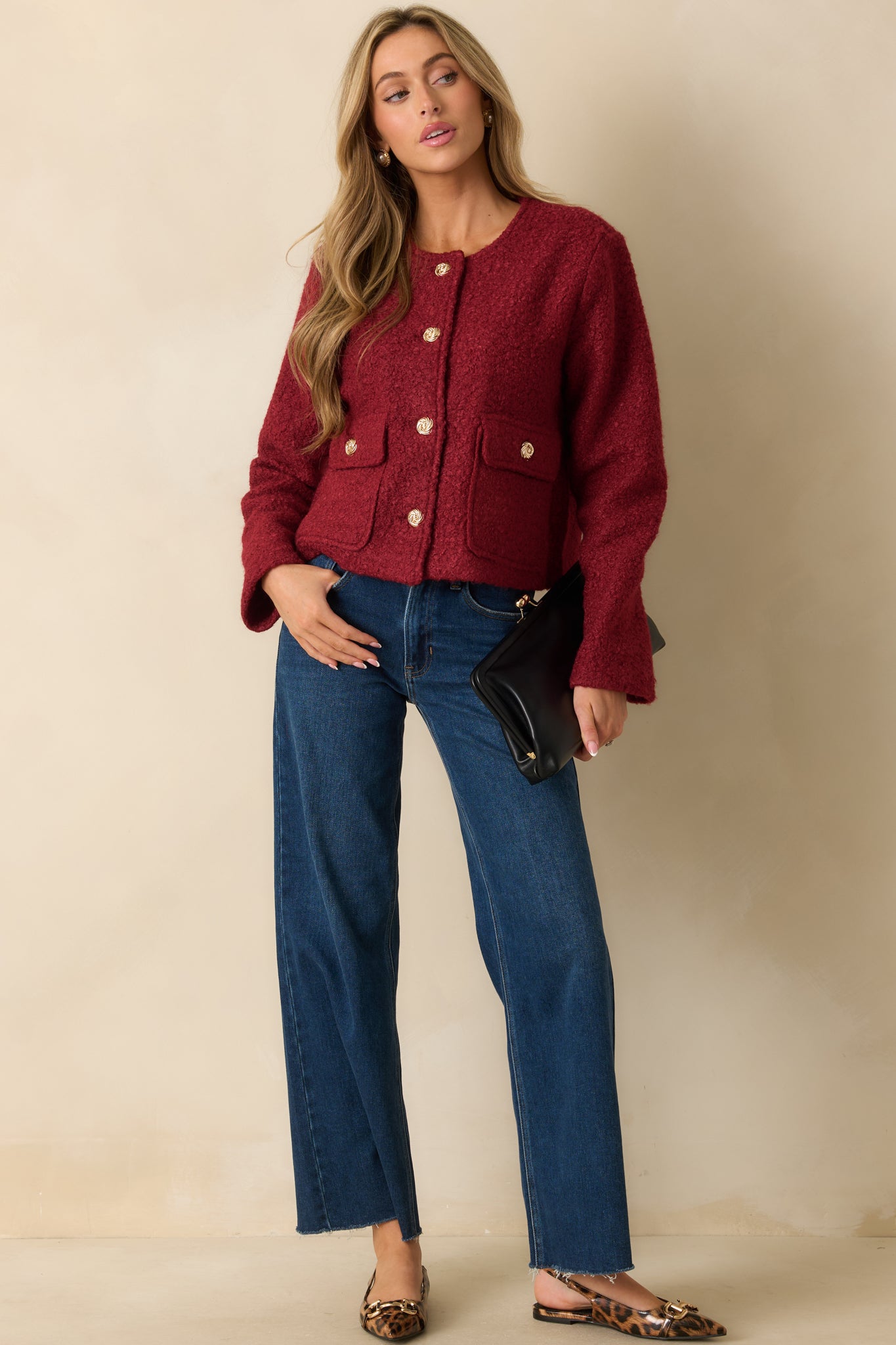 Elegant cherry red bouclé jacket with a structured fit, round neckline, and decorative gold buttons.