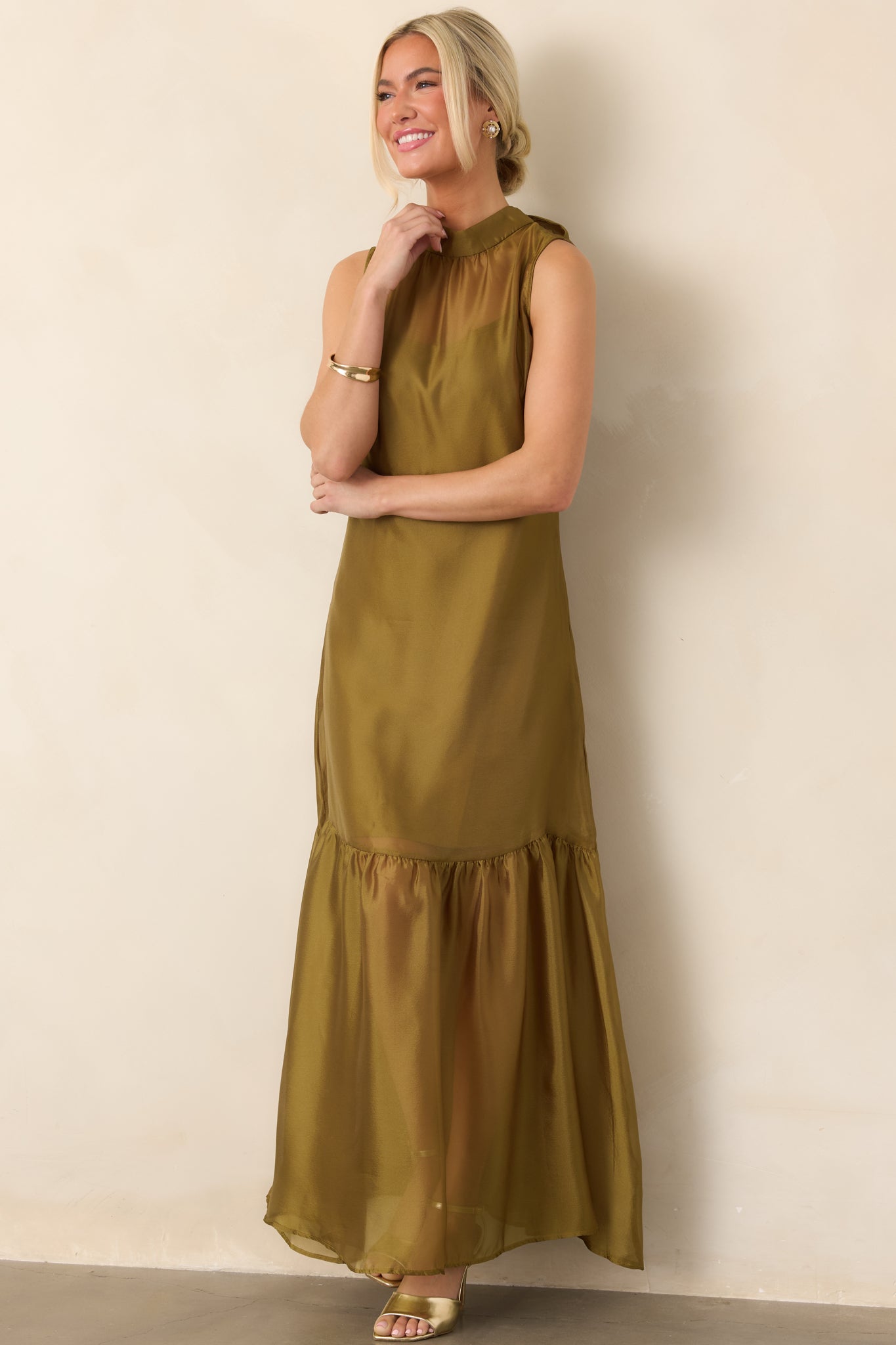 Elegant organza maxi dress featuring a lightweight sheer overlay, high collar, fluid floor-length skirt, and softly gathered hemline.
