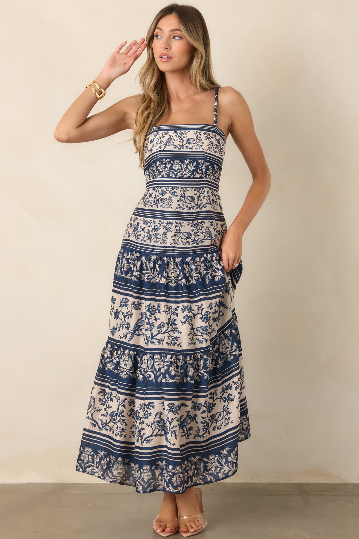 The elongated bodice transitions into gathered skirt tiers, creating a fluid long silhouette with plenty of volume.