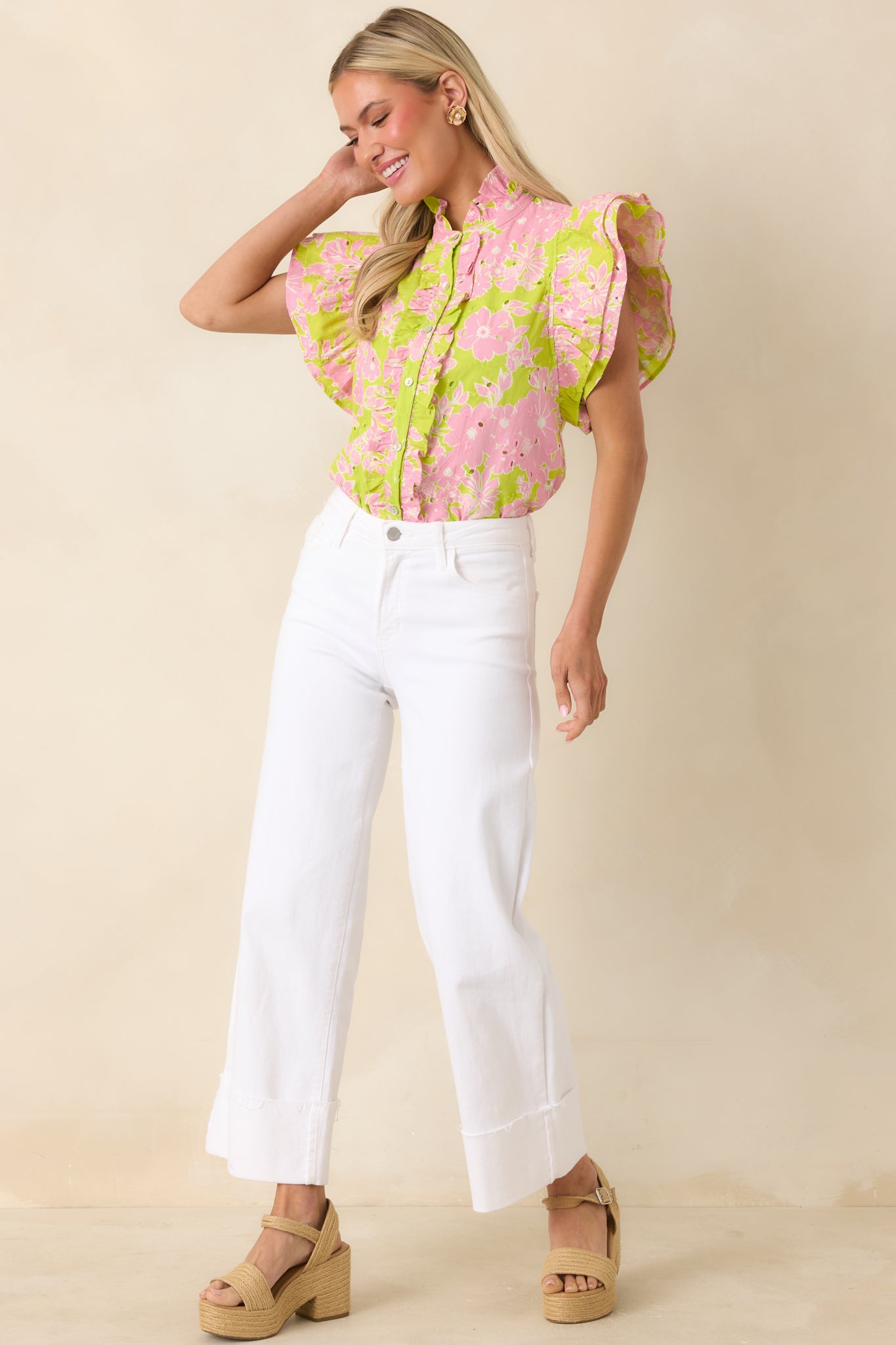 Embroidered eyelet top with floral pattern and relaxed silhouette.
