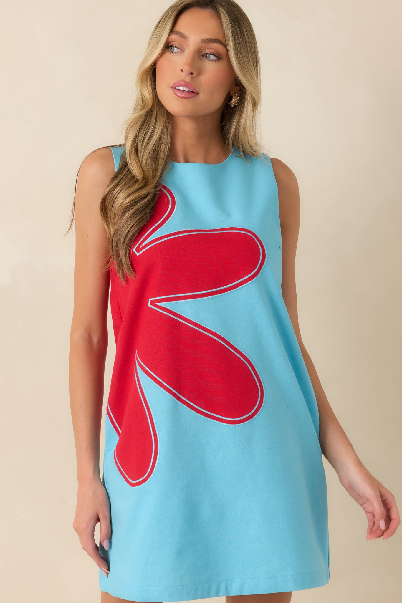 Embroidered appliqué detailing creates texture and dimension across the front of this artistic linen blend dress.
