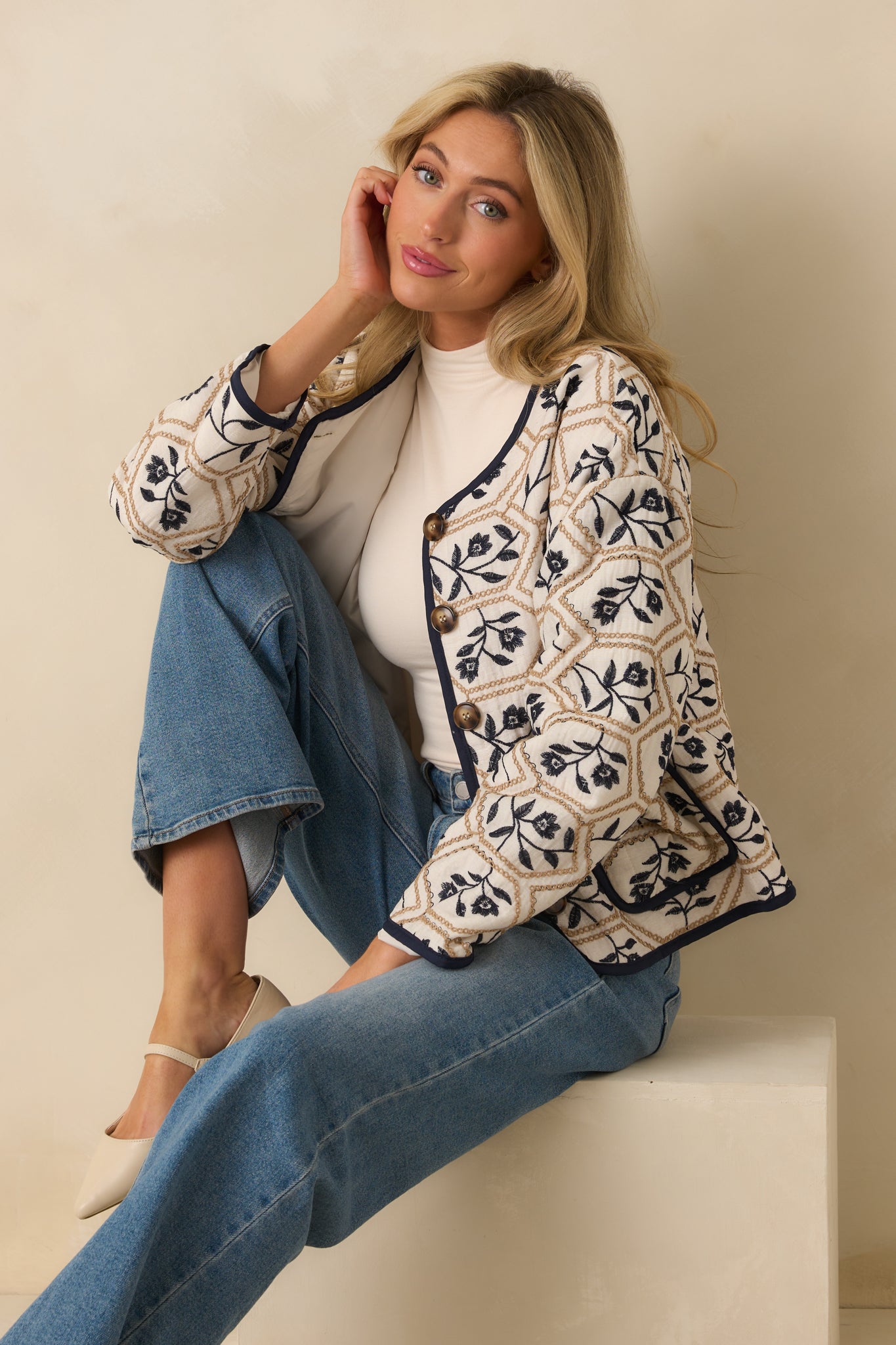 Embroidered jacket styled with long sleeves, round neckline, and a structured yet relaxed silhouette.