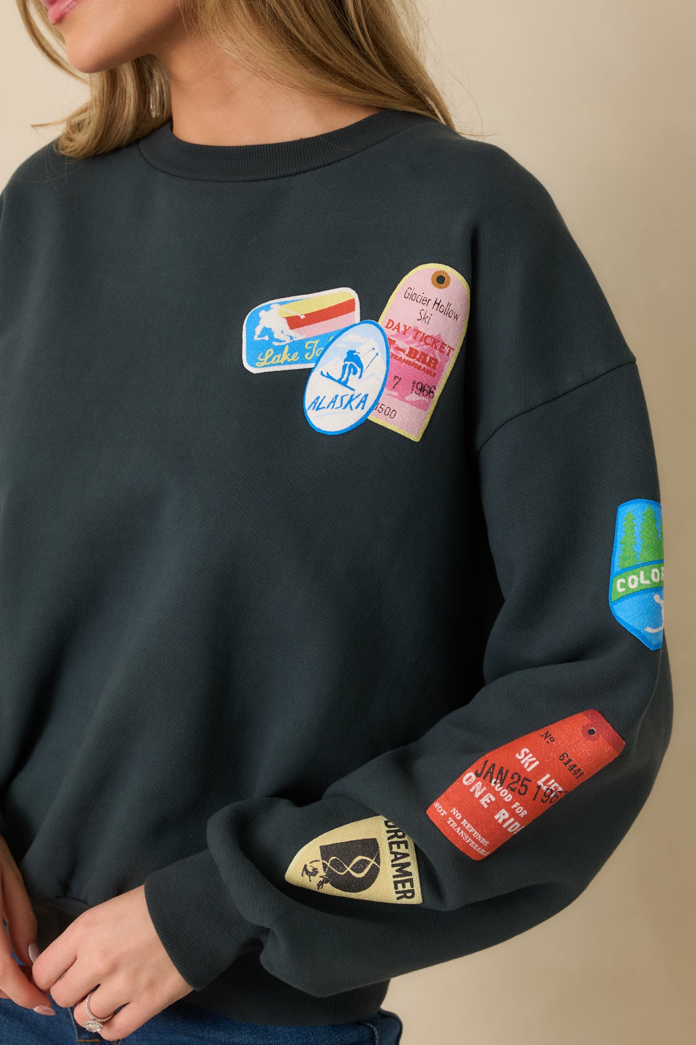 Clear view of the embroidered ski patches with multi-colored stitching and texture.