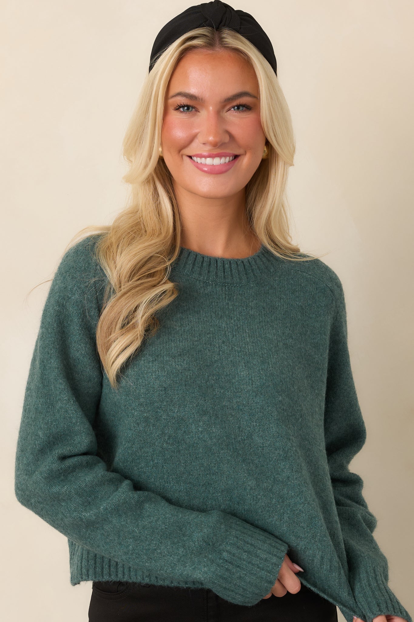 Close view of the Emerald Cove fuzzy knit top highlighting its classic crew neckline and soft textured finish.