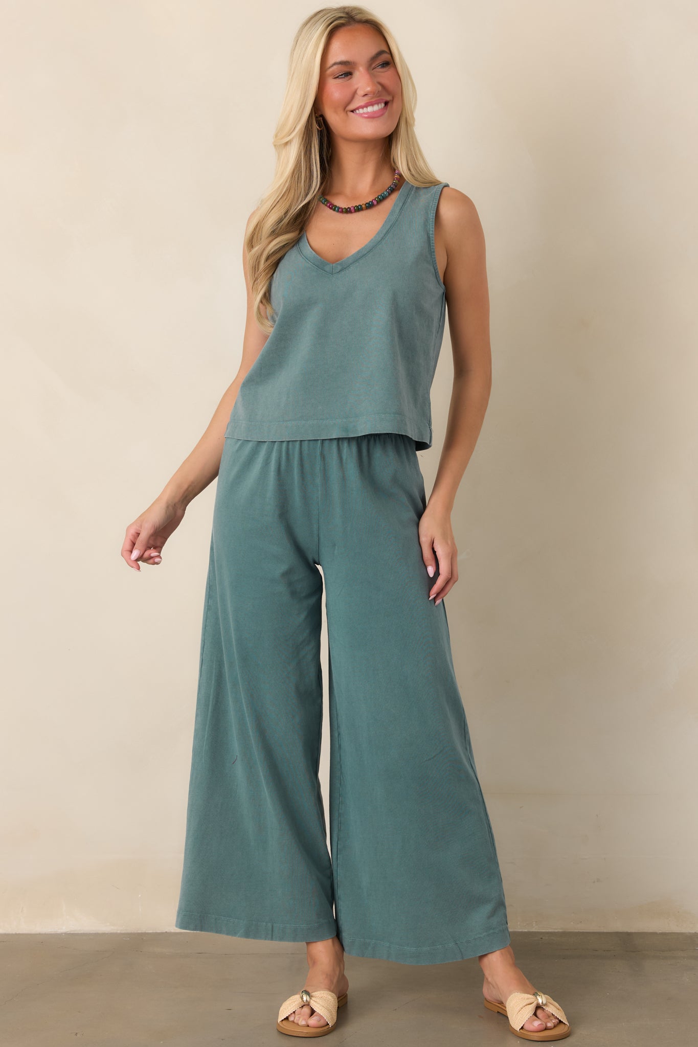 Emerald green sleeveless top with a relaxed silhouette, flattering V-neckline, and slightly shortened length.