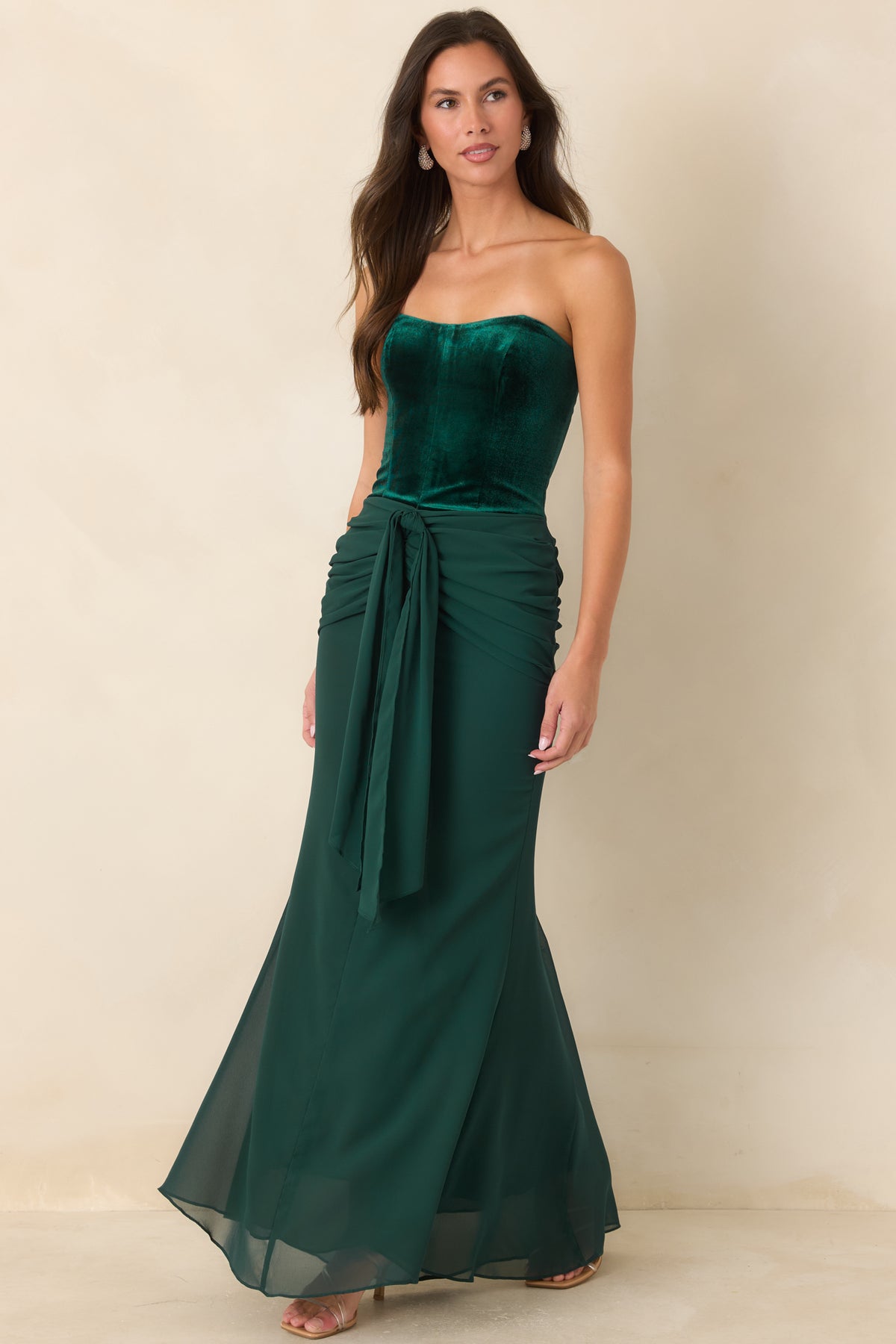 Emerald velvet dress with a curved strapless neckline and flowing maxi-length chiffon skirt.