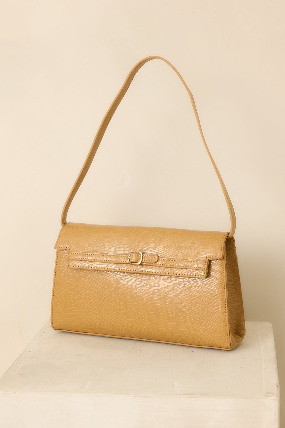 Envelope flap shoulder bag with a narrow strap and sleek, clean-lined silhouette.