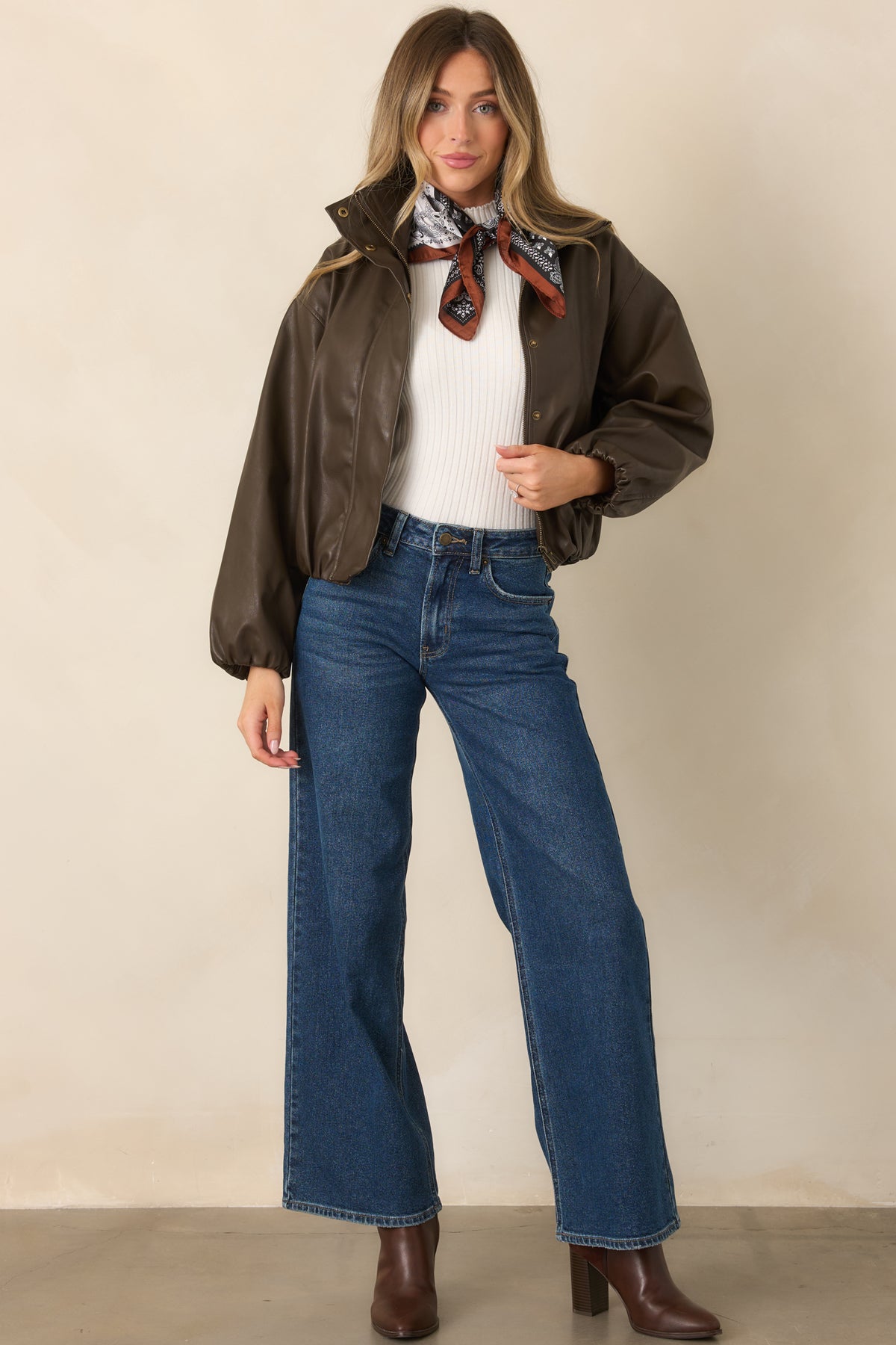 Rich espresso faux leather jacket with dramatic balloon sleeves, dropped shoulders, and a high stand collar.
