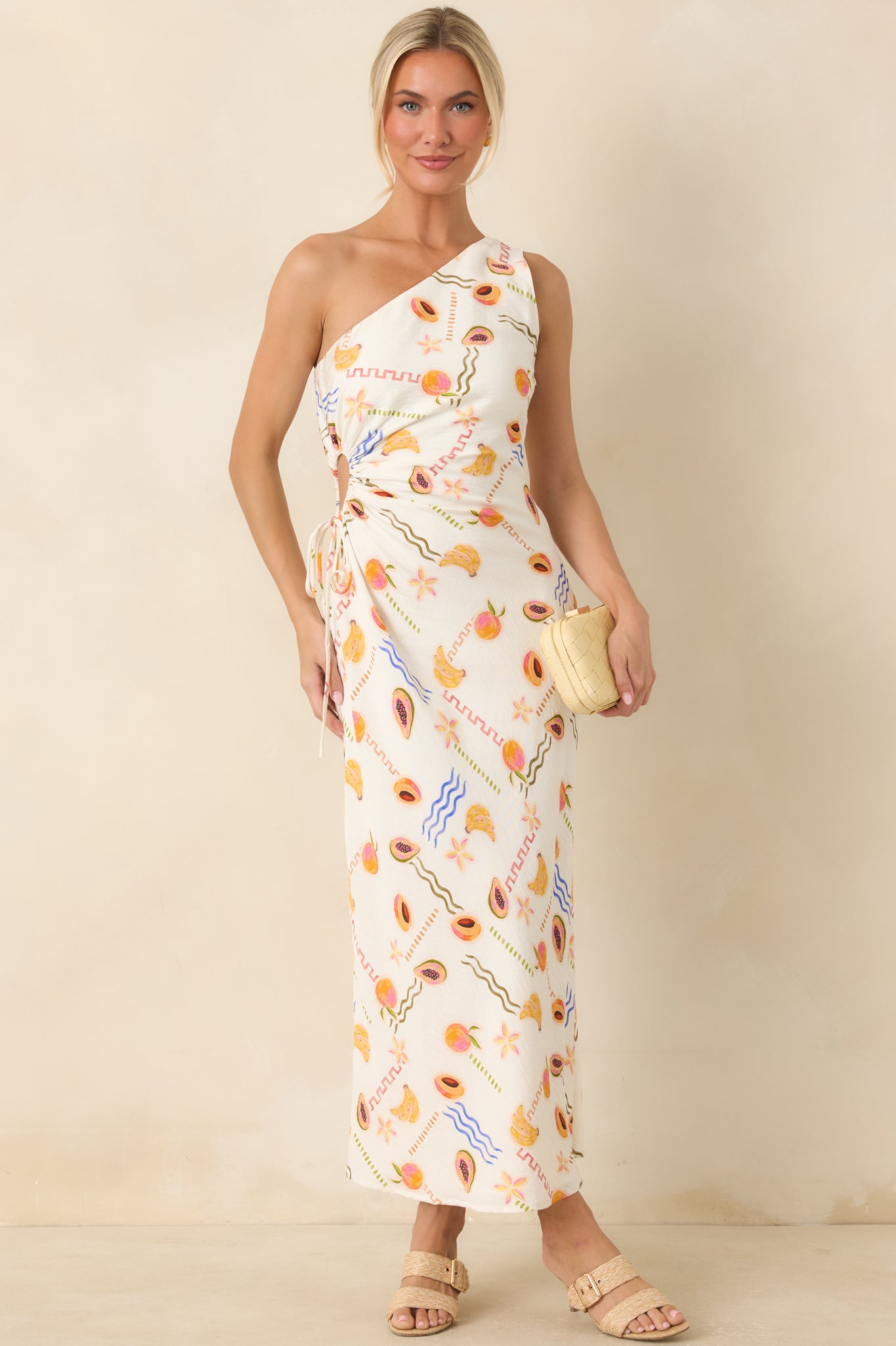 European summer-inspired maxi dress featuring a colorful fruit pattern and a graceful asymmetrical silhouette.