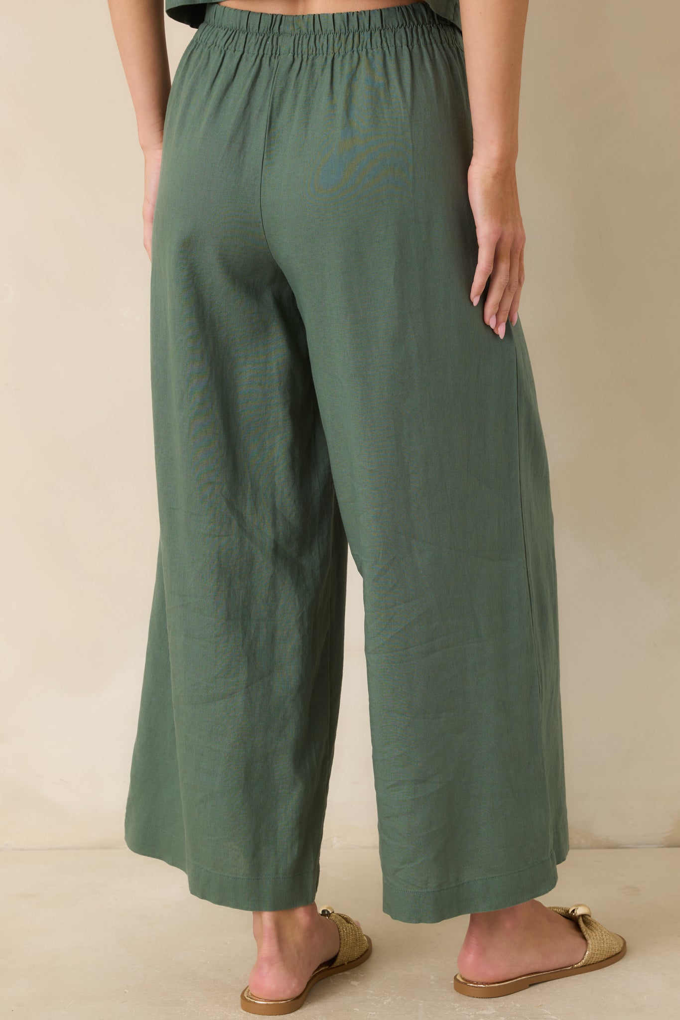 Back view of the everglade green pants highlighting the relaxed wide-leg silhouette, ankle-length cut, and comfortable fit.