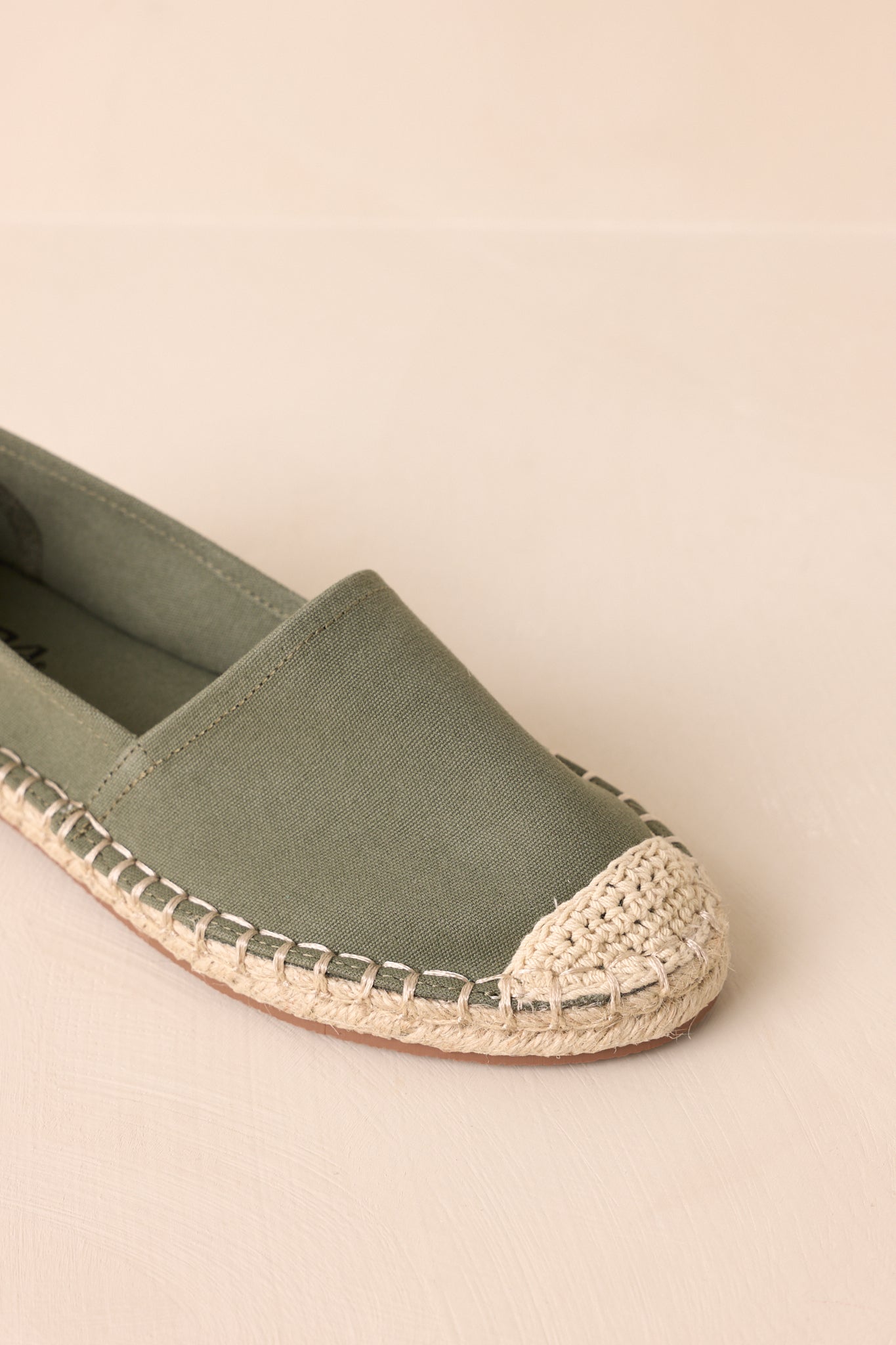 An extreme close-up of the crochet toe detail and canvas fabric, emphasizing texture and stitching quality.