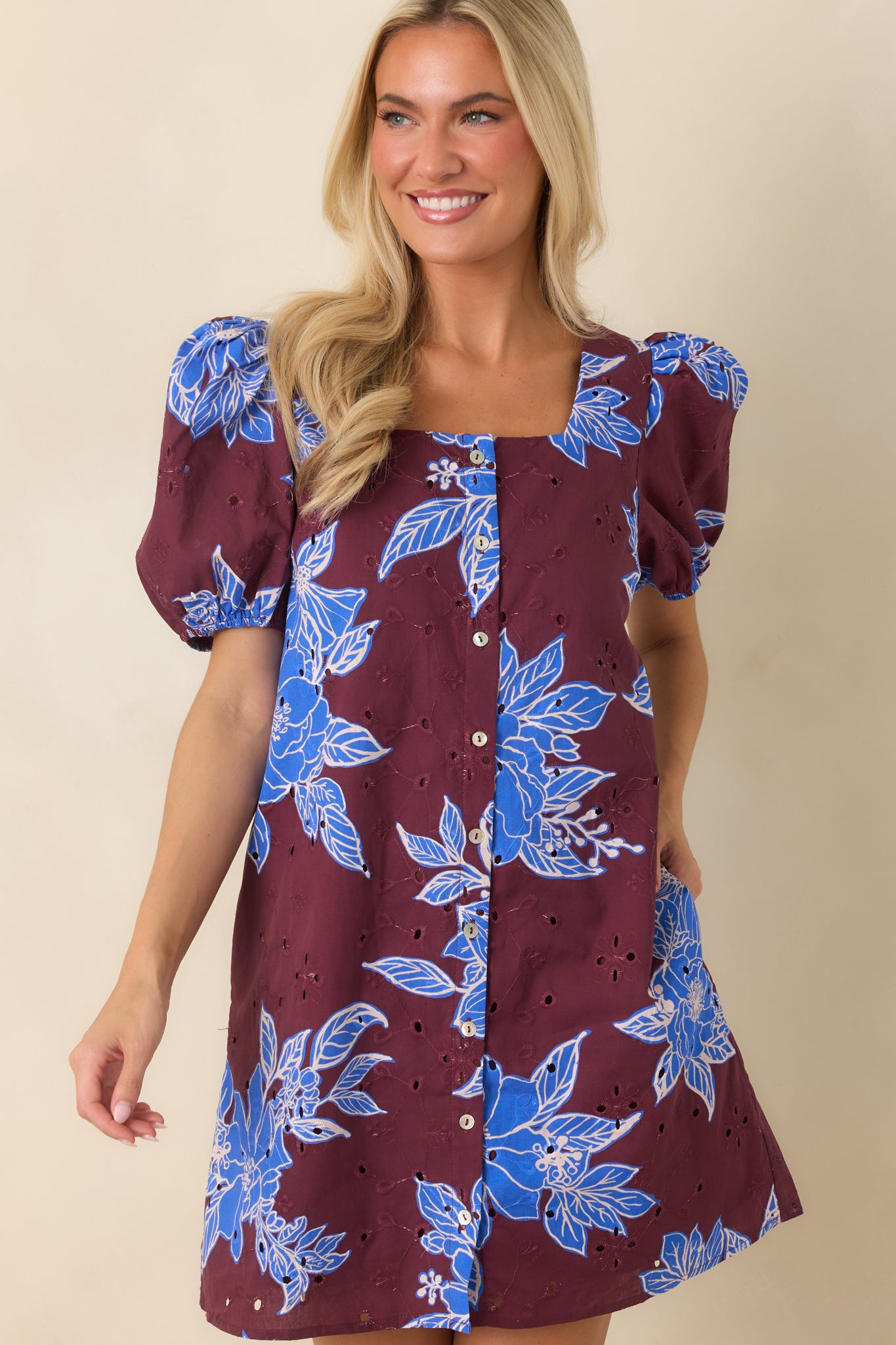 Eyelet cotton fabric showcasing delicate embroidery and oversized floral pattern details.