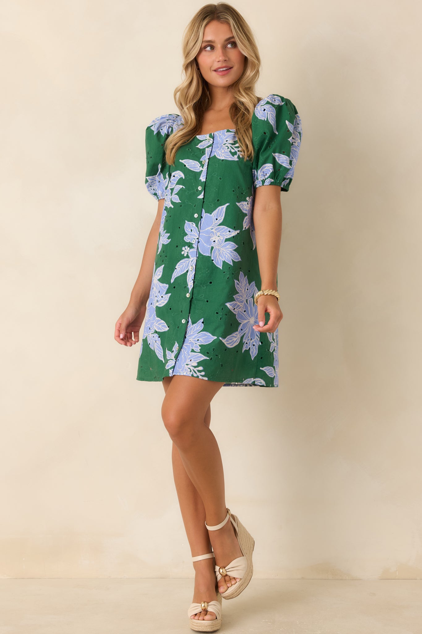 Eyelet embroidered shift dress featuring a button-front design, lined construction, puff sleeves, and oversized floral detailing.