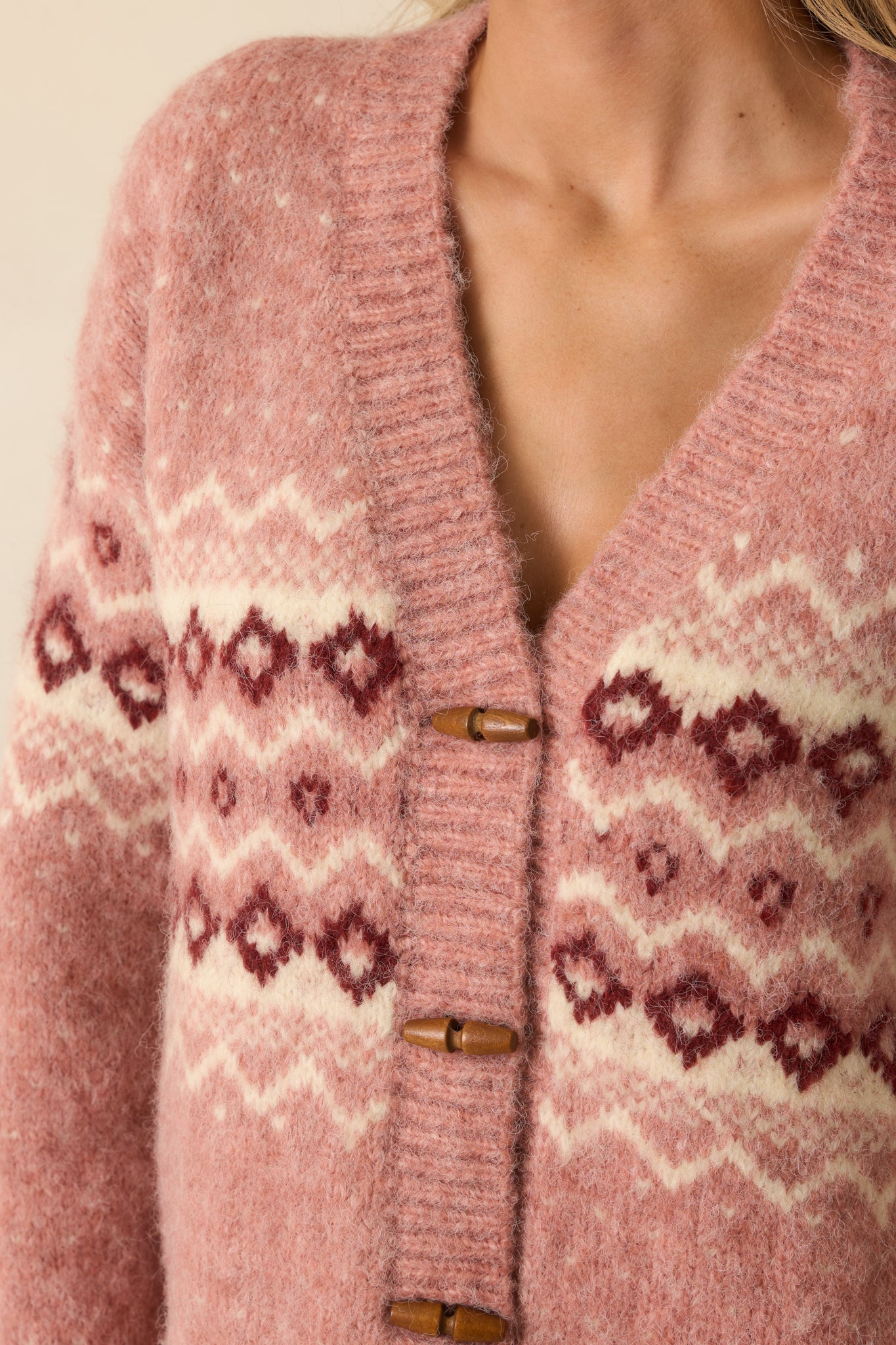 Detailed look at the Fair Isle pattern, wooden toggles, and knit texture on the cardigan.