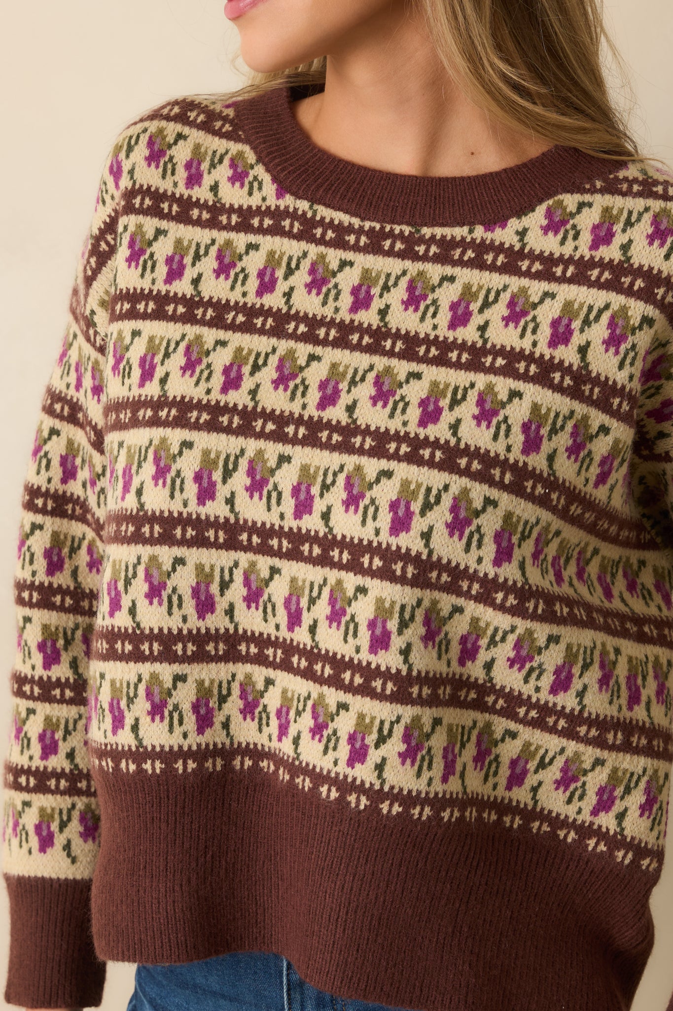 Detailed look at the ivory, purple, and green Fair Isle pattern, highlighting the knit texture and stitching.
