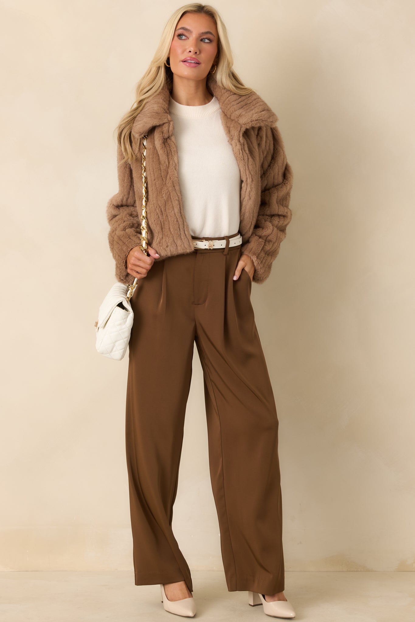 Mocha brown faux fur jacket with subtle ribbed texture, wide collar, long sleeves, and a relaxed cropped fit with hook-and-eye closures.