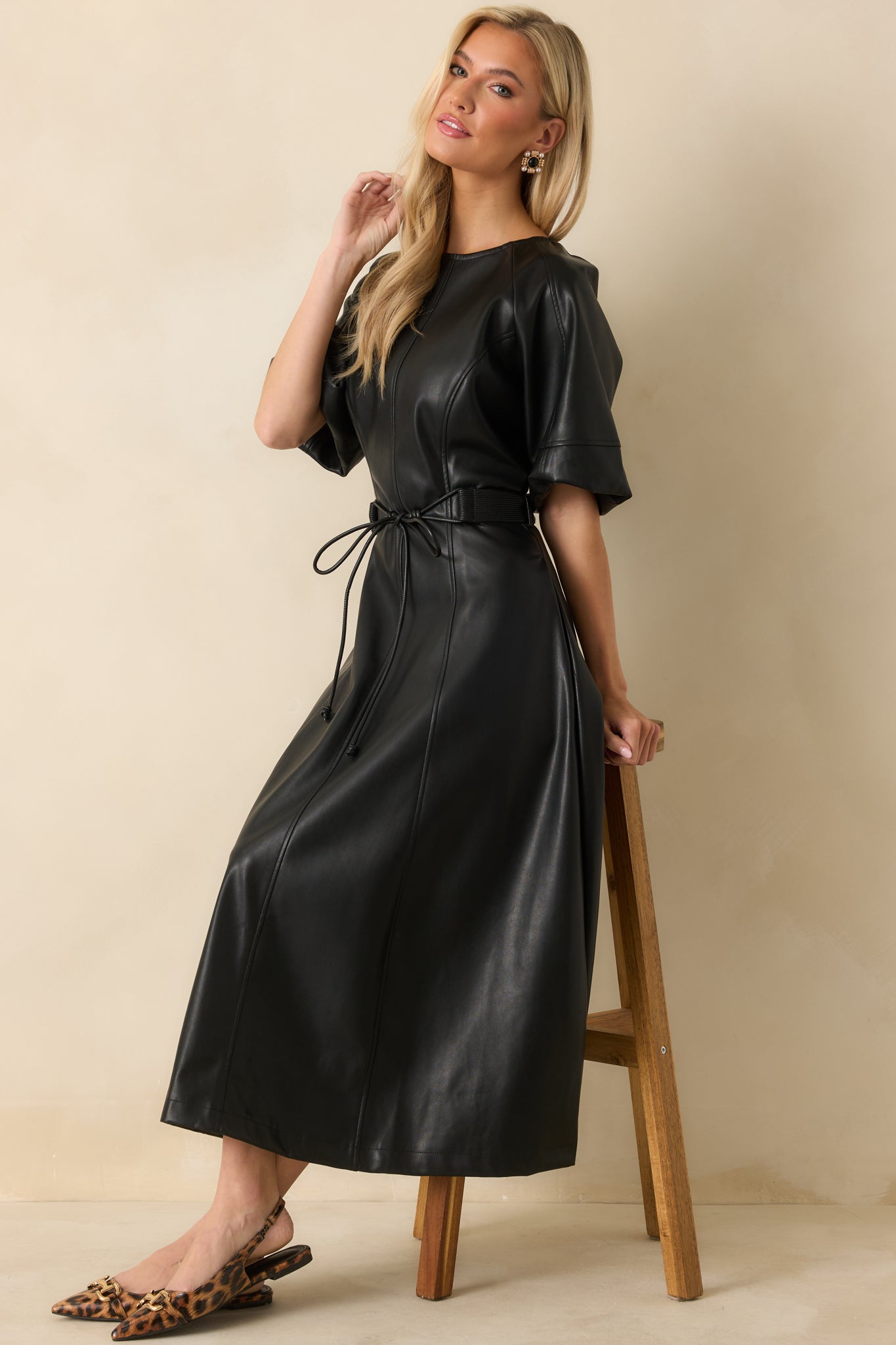 Faux leather midi dress with a refined front profile, subtle sheen, and softly structured movement.