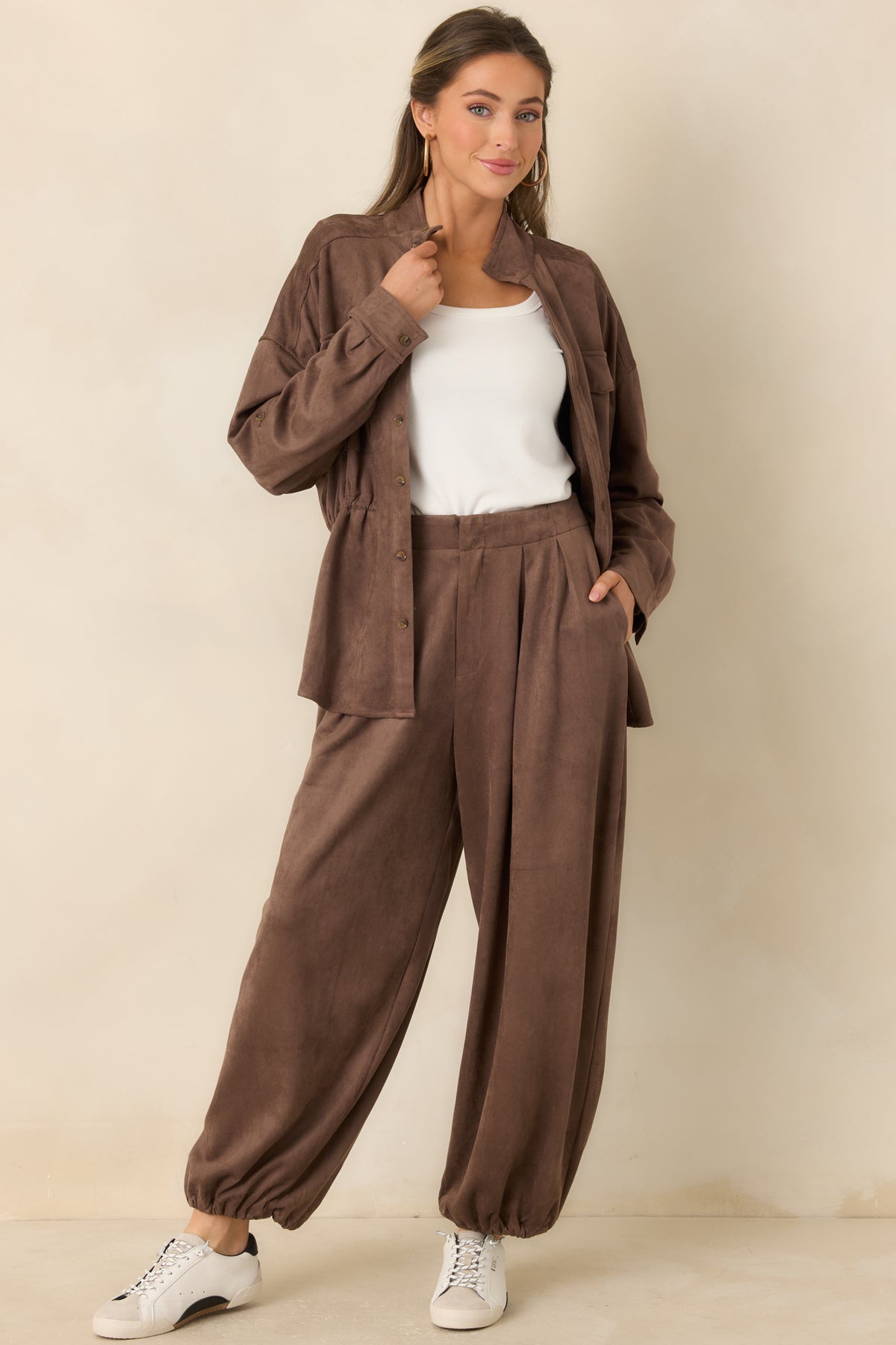 Faux suede balloon pants with front pleats, roomy legs, and gathered ankle hems.