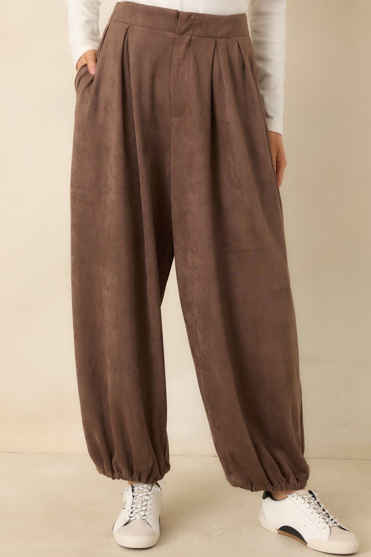 Gathered ankle hems define the rounded balloon shape of the faux suede pants.